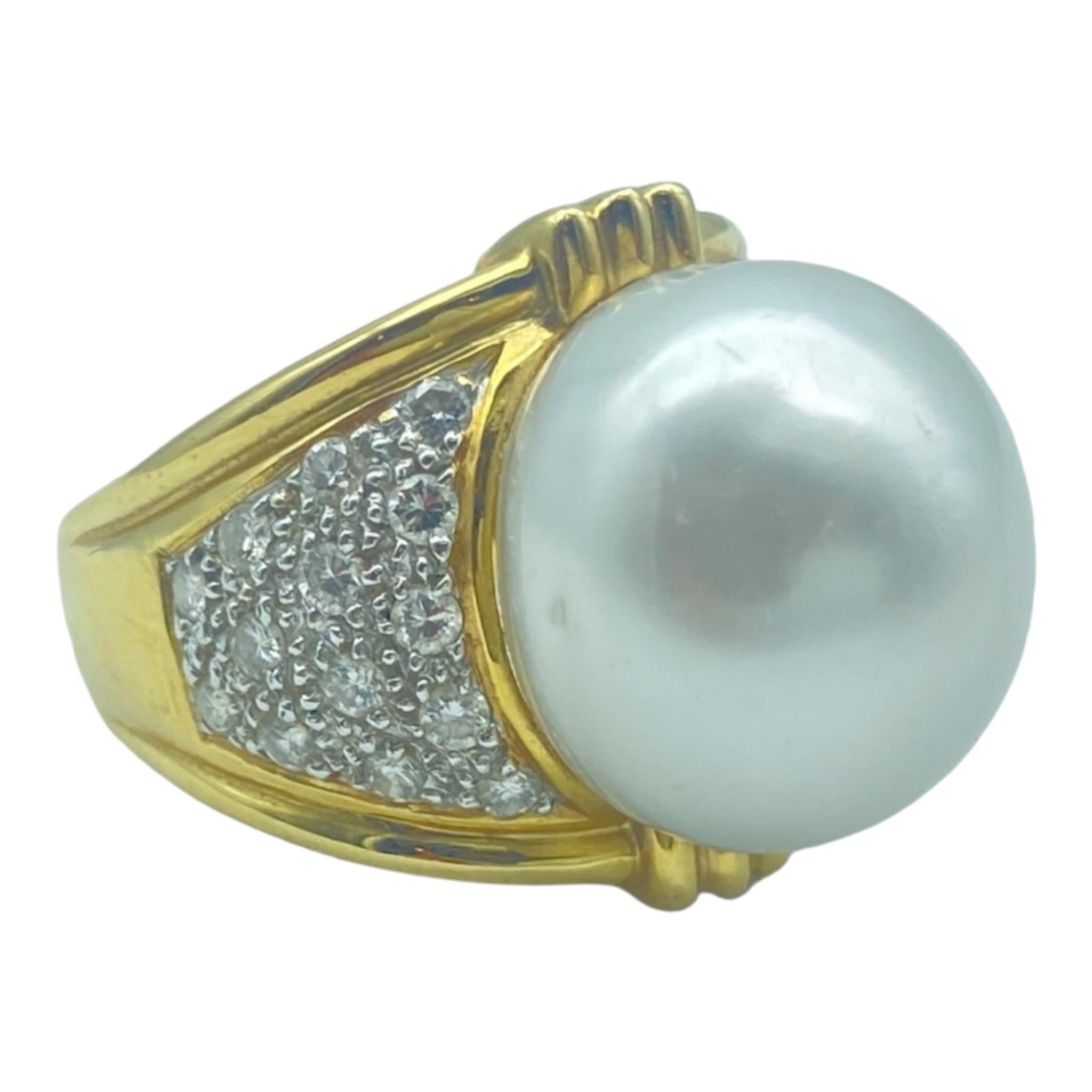 This large South Sea pearl has a great color and lustrous shine; The pearl is 17mm set in a heavy yellow gold setting made from 18 karat gold. The contemporary style is desirable, with the pave diamonds on the ground measuring 21 mm and 14.61 mm