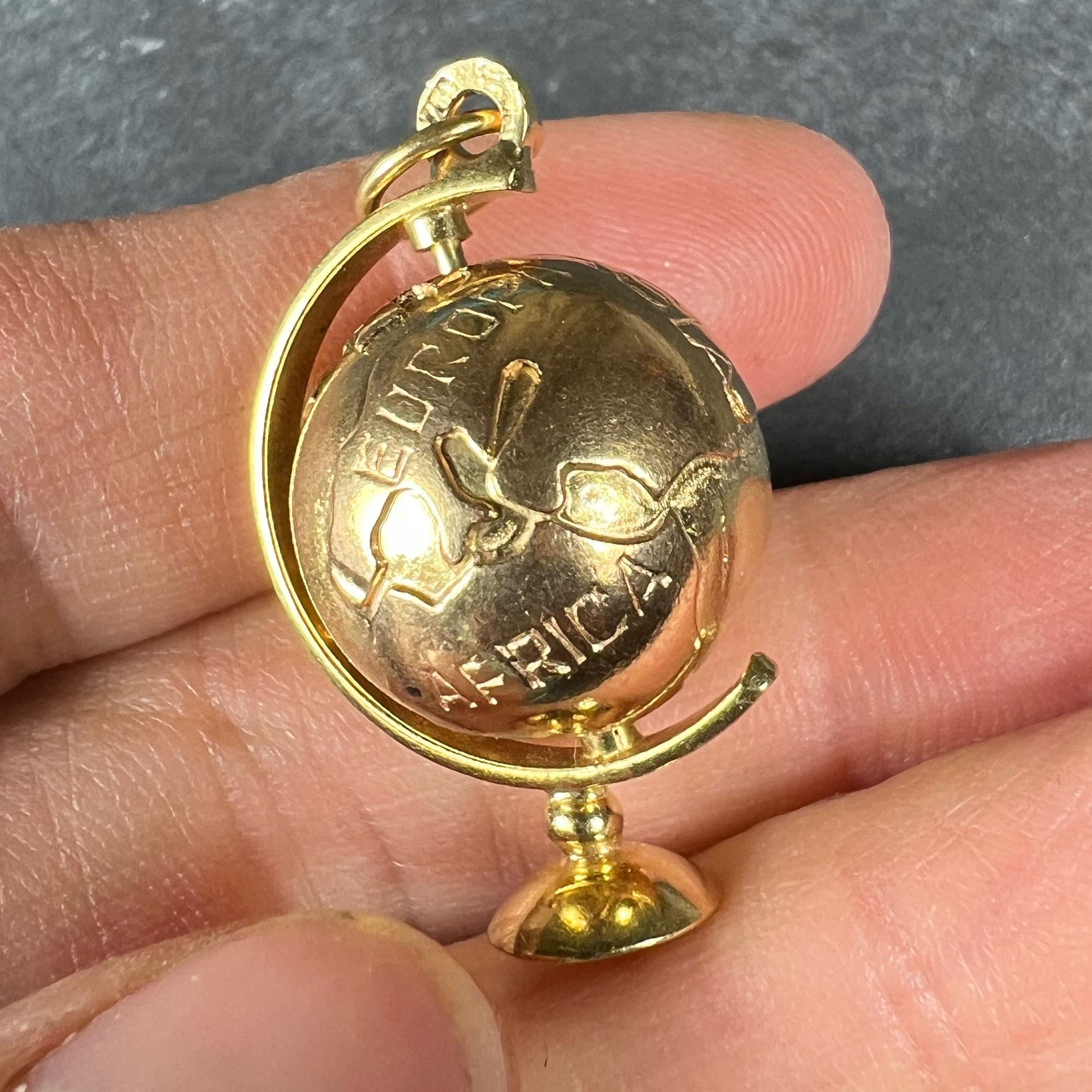 An 18 karat (18K) yellow gold charm pendant designed as a spinning globe. Stamped 750 for 18 karat gold.

Dimensions: 3 x 2 x 1.5 cm (not including jump ring)
Weight: 7.49 grams
