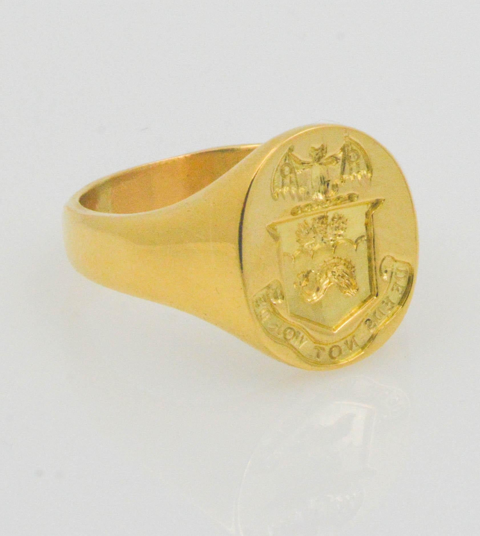 This bold and masculine ring conveys a strong message for the proud man in your life. Set in 18K yellow gold with a brilliant shine and polish; this signet ring has an English crest with a banner saying 'words not deeds'. 

The ring is stamped with
