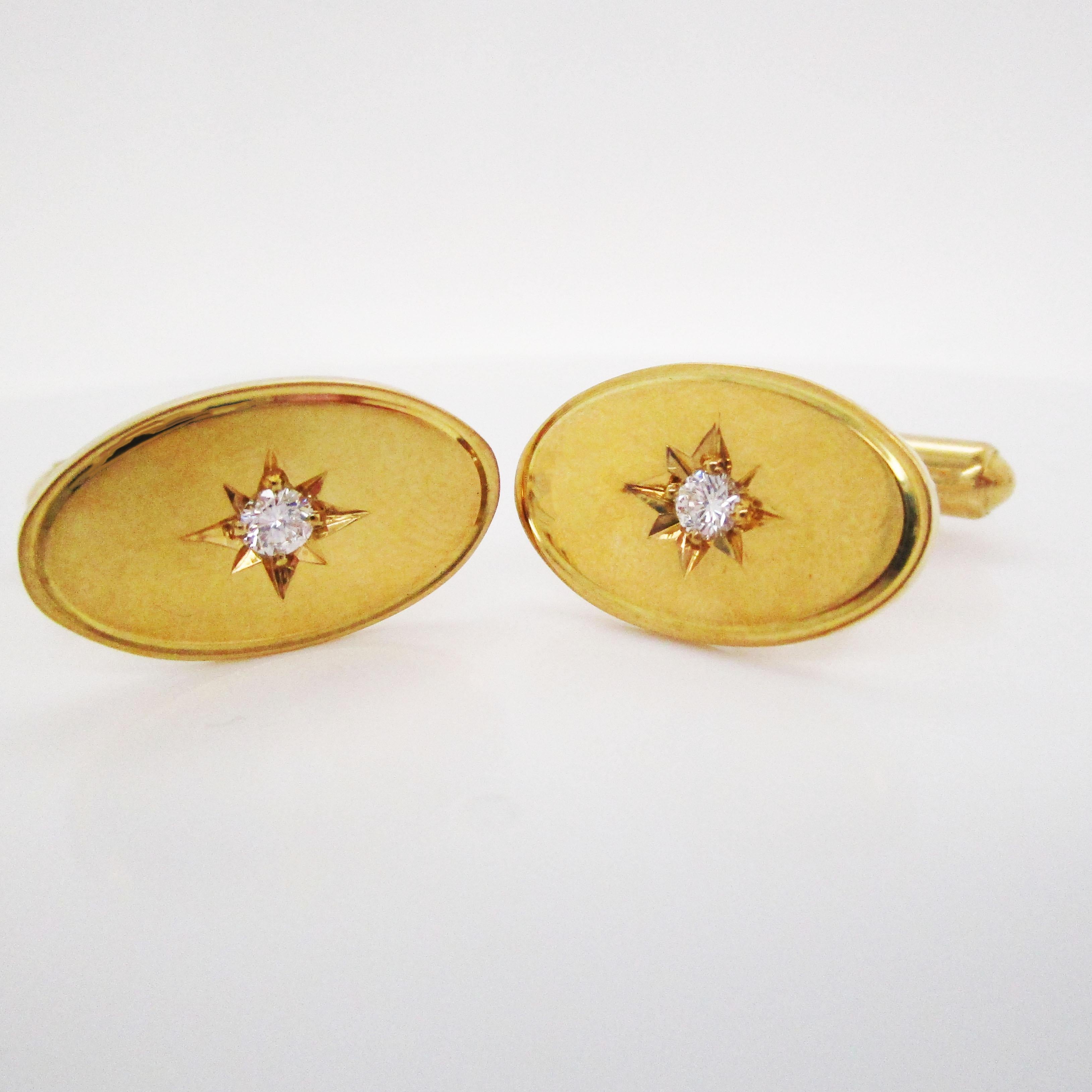 These cufflinks are rich 18k yellow gold and boast a gorgeous brilliant white diamond nestled in the center of the star set detailing on an oval panel. The classic oval star set design makes them elegant, understated, and sophisticated. At the
