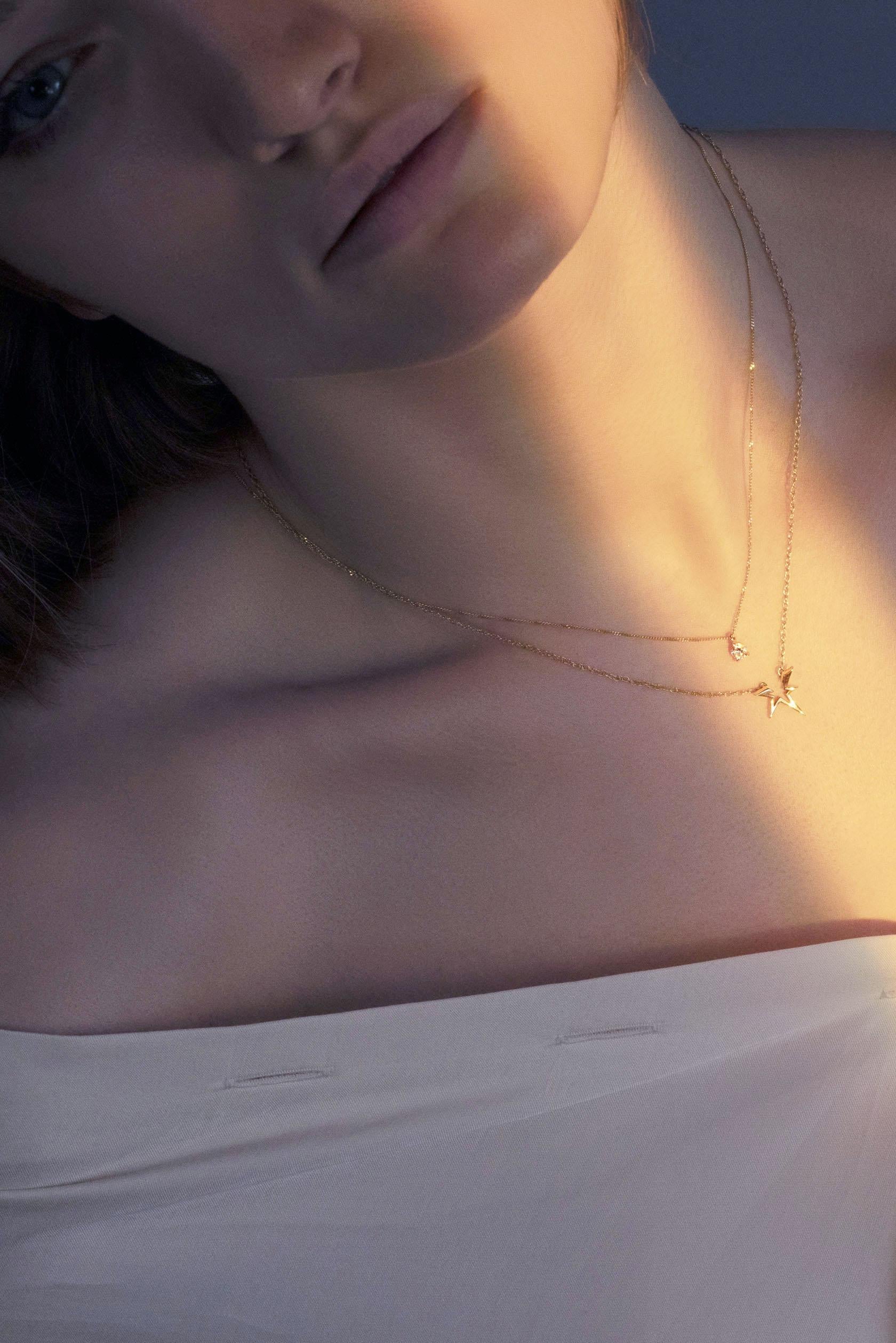 This modern gold necklace is designed for daily wear, featuring a brilliant-cut diamond set in a distinctive and eye-catching style. Handcrafted in 18K yellow gold, this statement necklace exudes understated elegance, making it a versatile staple in