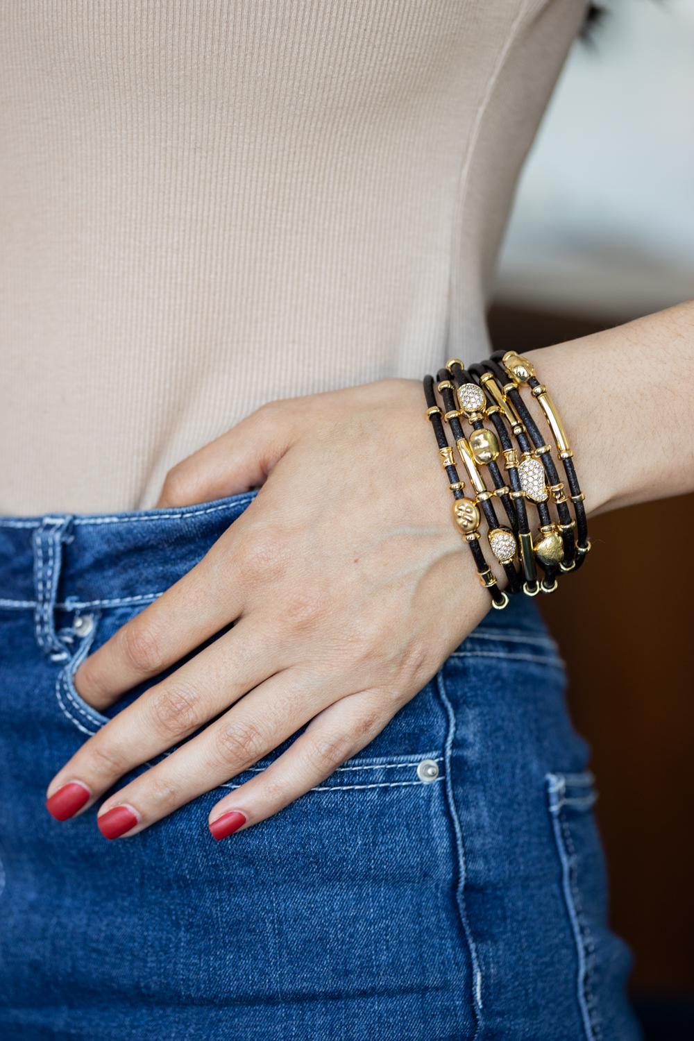 Our seven-strand bracelet crafted from luxurious 3 mm leather is a harmonious blend of rugged charm and refined sophistication. Each of its seven strands is adorned with handmade 18K gold and sterling silver elements, further embellished with