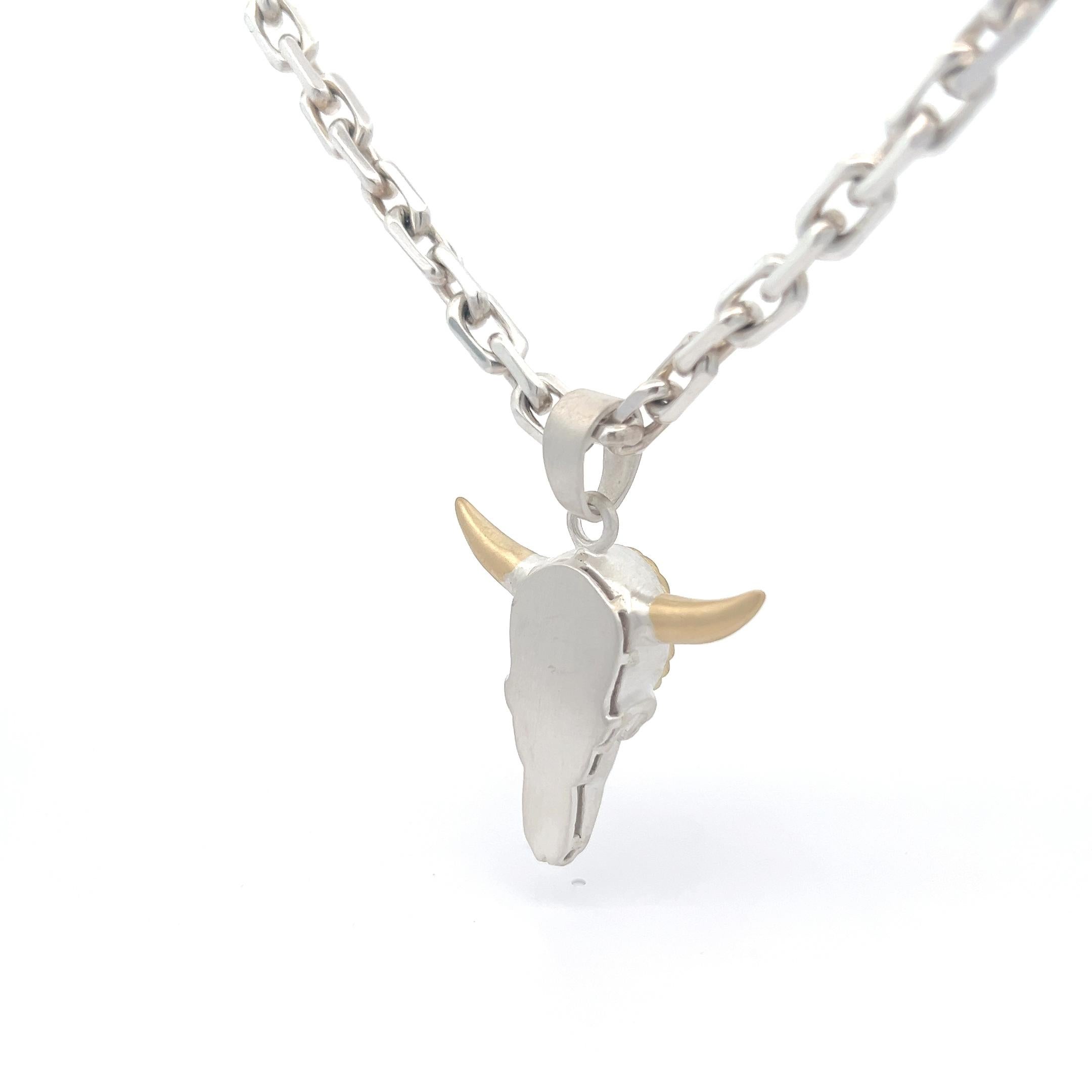 Elevate your accessory game with this stunning pendant necklace, a true testament to artisan craftsmanship and timeless style. Crafted from sterling silver and accented with luxurious 18k yellow gold, the centerpiece of this necklace features a