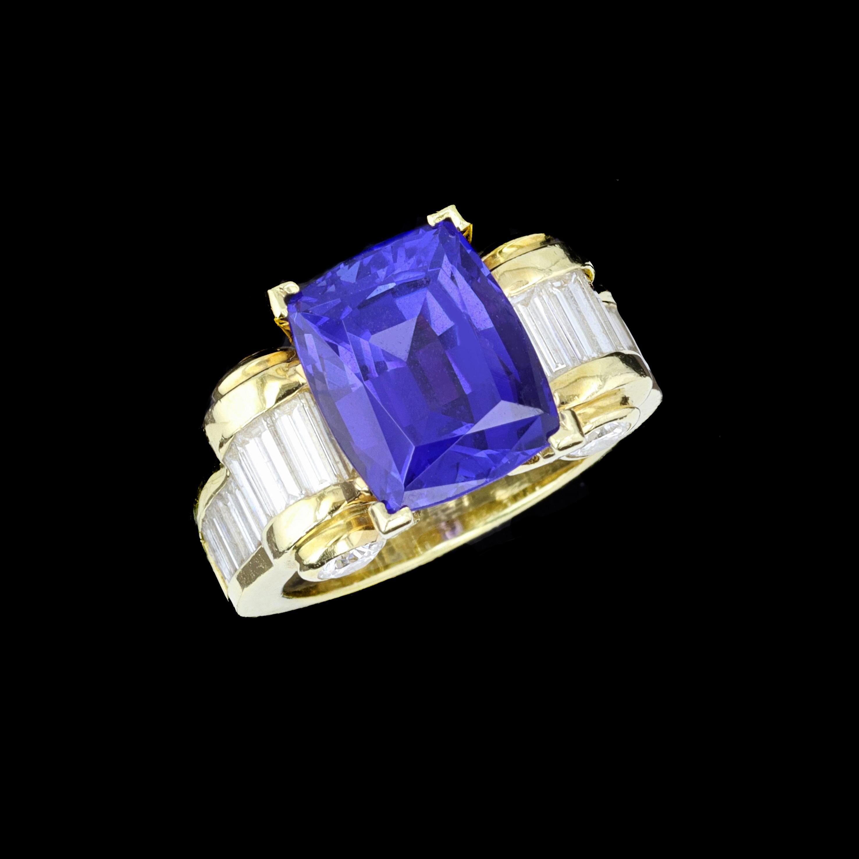 The ultimate cocktail ring to catch everyone's attention. Crafted in 18 karat yellow gold, an emerald cut 6.00 carat tanzanite shines at the center of the ring. Baguette and round cut diamonds accentuate this remarkable center stone. The ring is