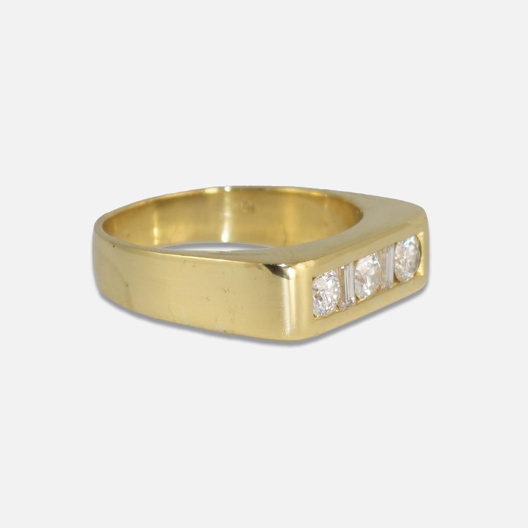 Men's 18k yellow gold three-diamond ring.
Stamped 18k and weighs 13 grams.
There are three round brilliant cut diamonds and two baguettes, .95 total carats, G, H, I color range, VS to SI clarity.
The top of the ring measures 6.5mm wide.
Ring size is