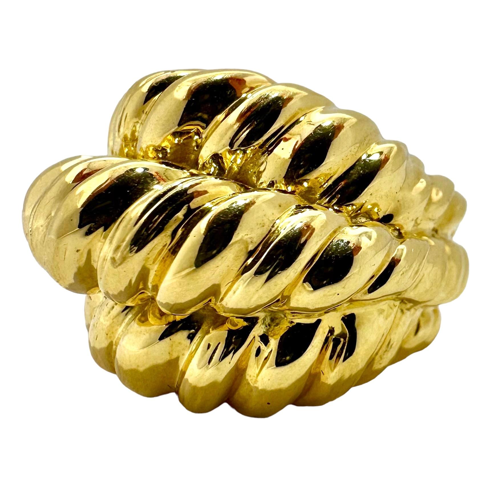 A shrimp style 18 karat yellow gold statement ring comprised of three rows of twisted rope design in a high dome. Tapers in width from 7/8 of an inch at the widest point in front down to a comfortable 3/8 of an inch at the rear. The high dome