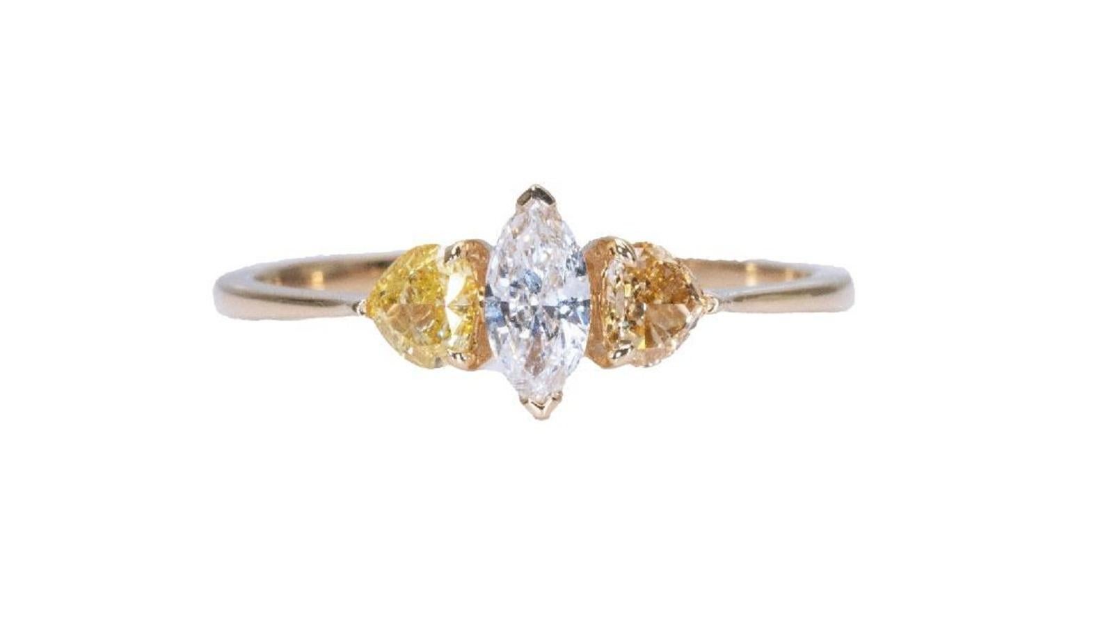 Beautiful 3 stone ring made from 18k yellow gold with 0.54 total carat of marquise cut diamond and fancy heart shape side diamonds. This ring comes with an AIG report and a fancy box.

1 diamond main stone of 0.20 ct.
cut: marquise
color: D
clarity: