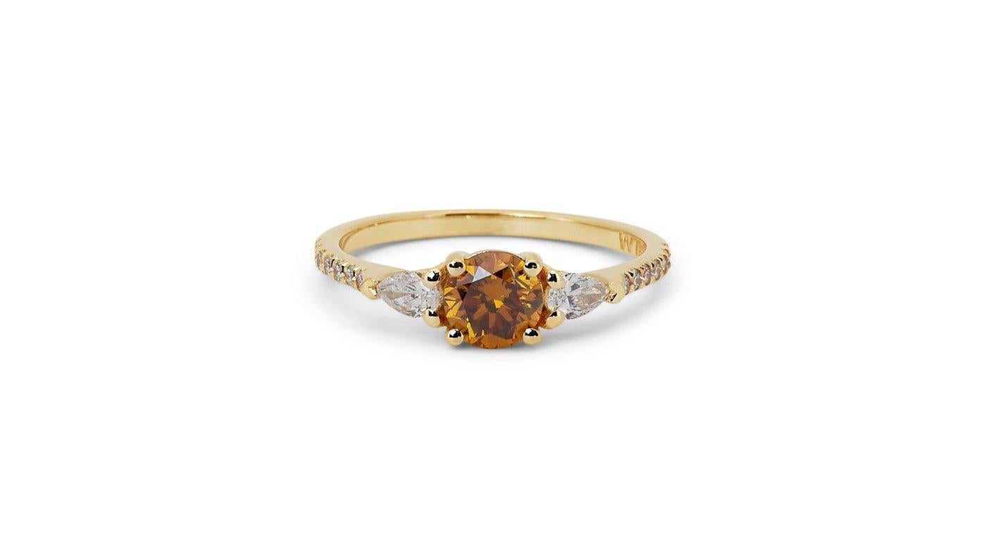 A gorgeous three stone pave ring with a dazzling 0.64 carat round brilliant natural diamond. It has 0.32 carat of side diamonds which add more to its elegance. The jewelry is made of 18K Yellow Gold with a high quality polish. It comes with GIA