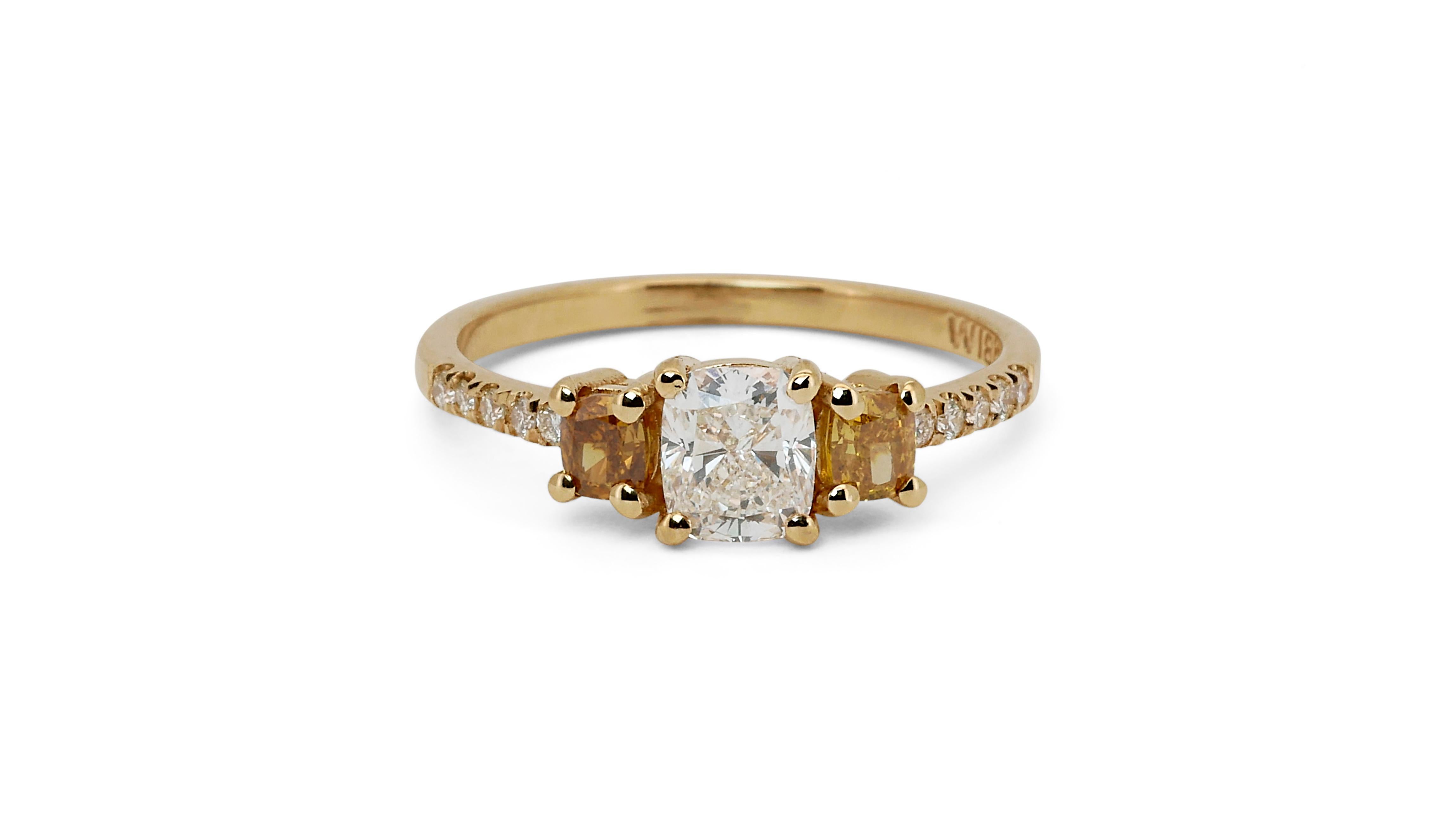 An elegant three stone ring with a dazzling 0.7 carat cushion natural diamond. It has 0.48 carat of side diamonds which add more to its elegance. The jewelry is made of 18K Yellow Gold with a high quality polish. It comes with AIG certificate and a