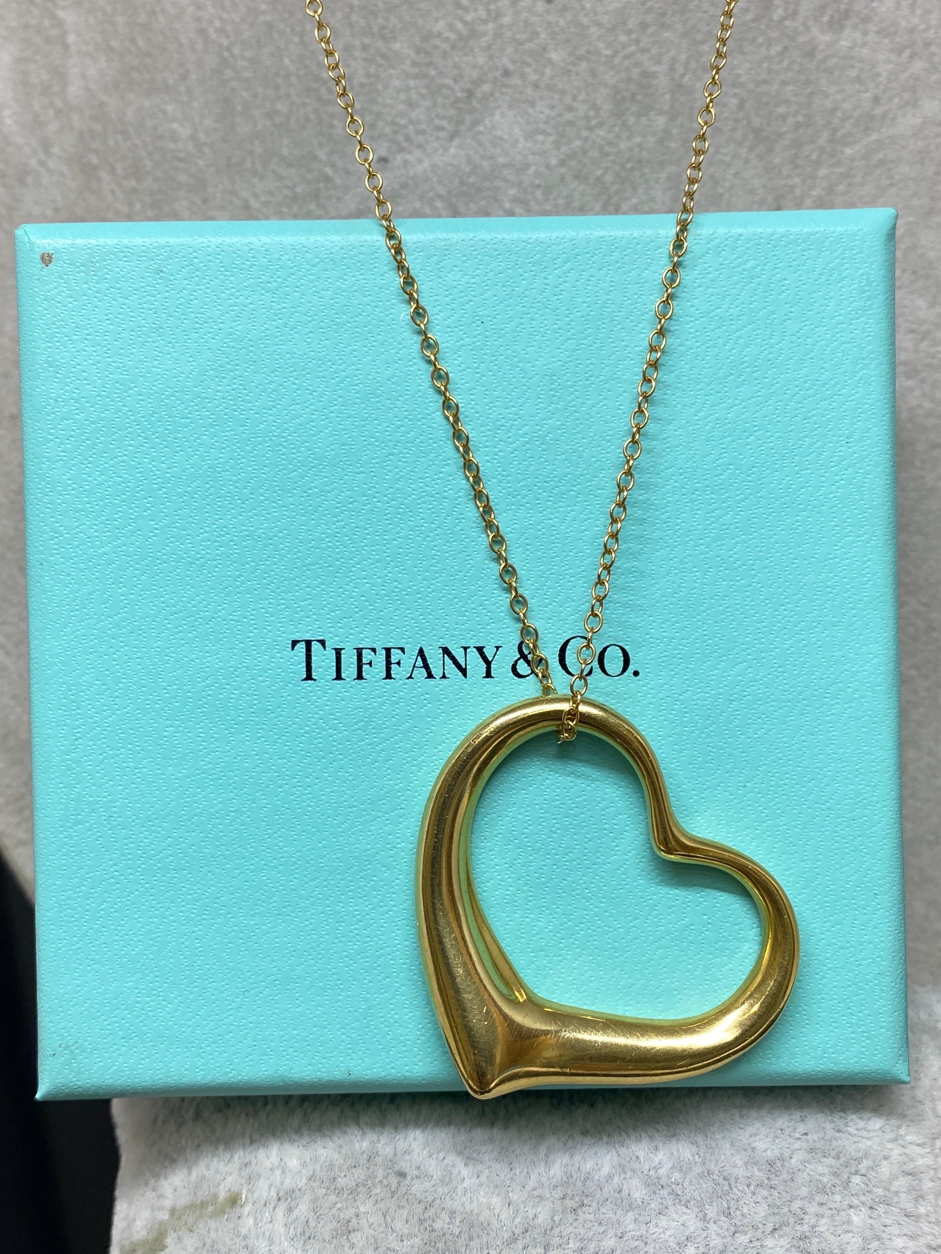 Up for your consideration is this iconic pendentif necklace by Elsa Peretti for Tiffany & Co.

La forme simple et classique des designs Open Heart d'Elsa Peretti célèbre l'esprit de l'amour. Cette élégante création est l'une de ses icones les plus
