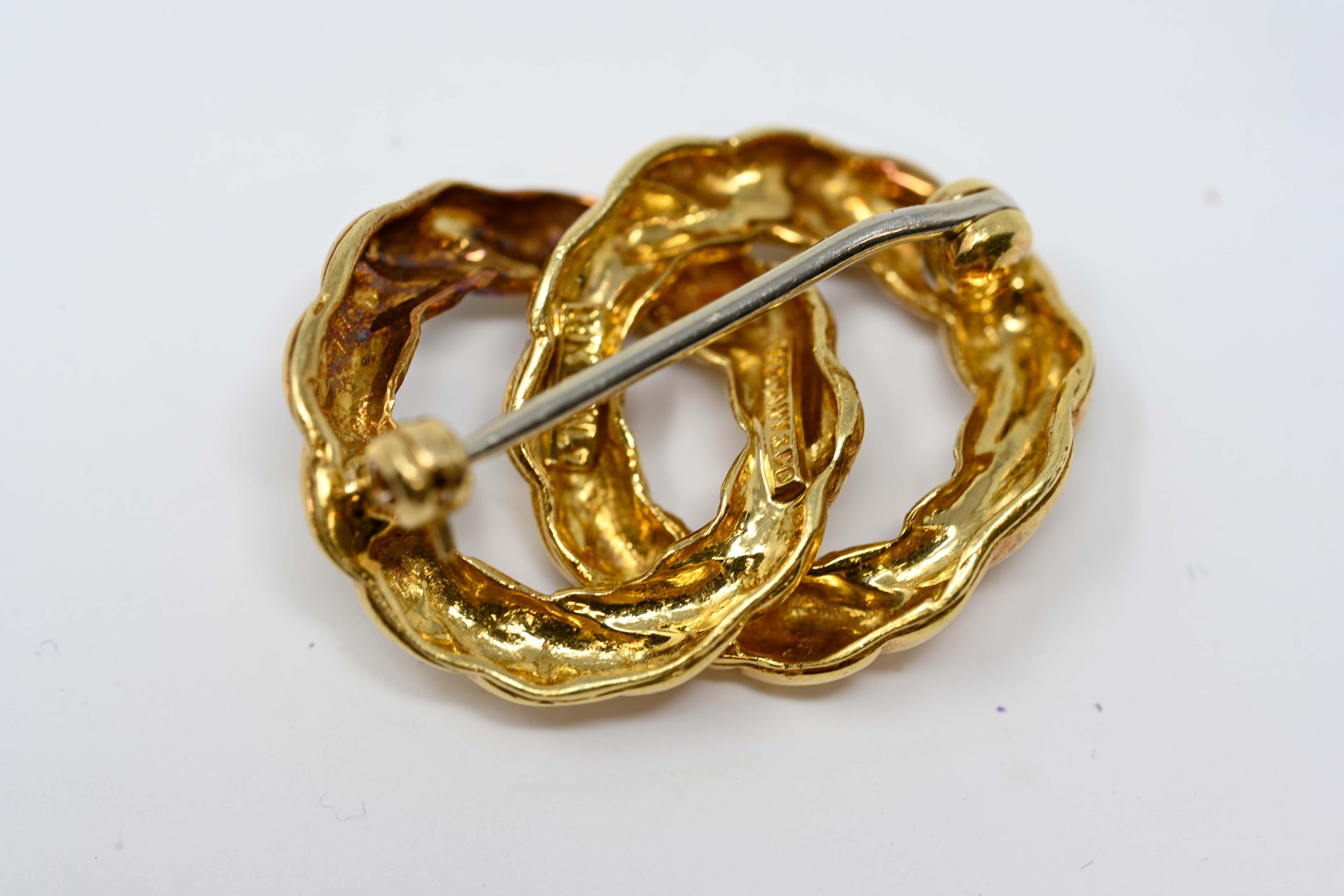Tiffany & Co. 18k yellow gold rope knot twist brooch. Signed on the back, measures 18.5 mm tall x 26mm long. Preowned, in good condition, made in Italy during the late 20th century. Weighs 6.7 grams. 