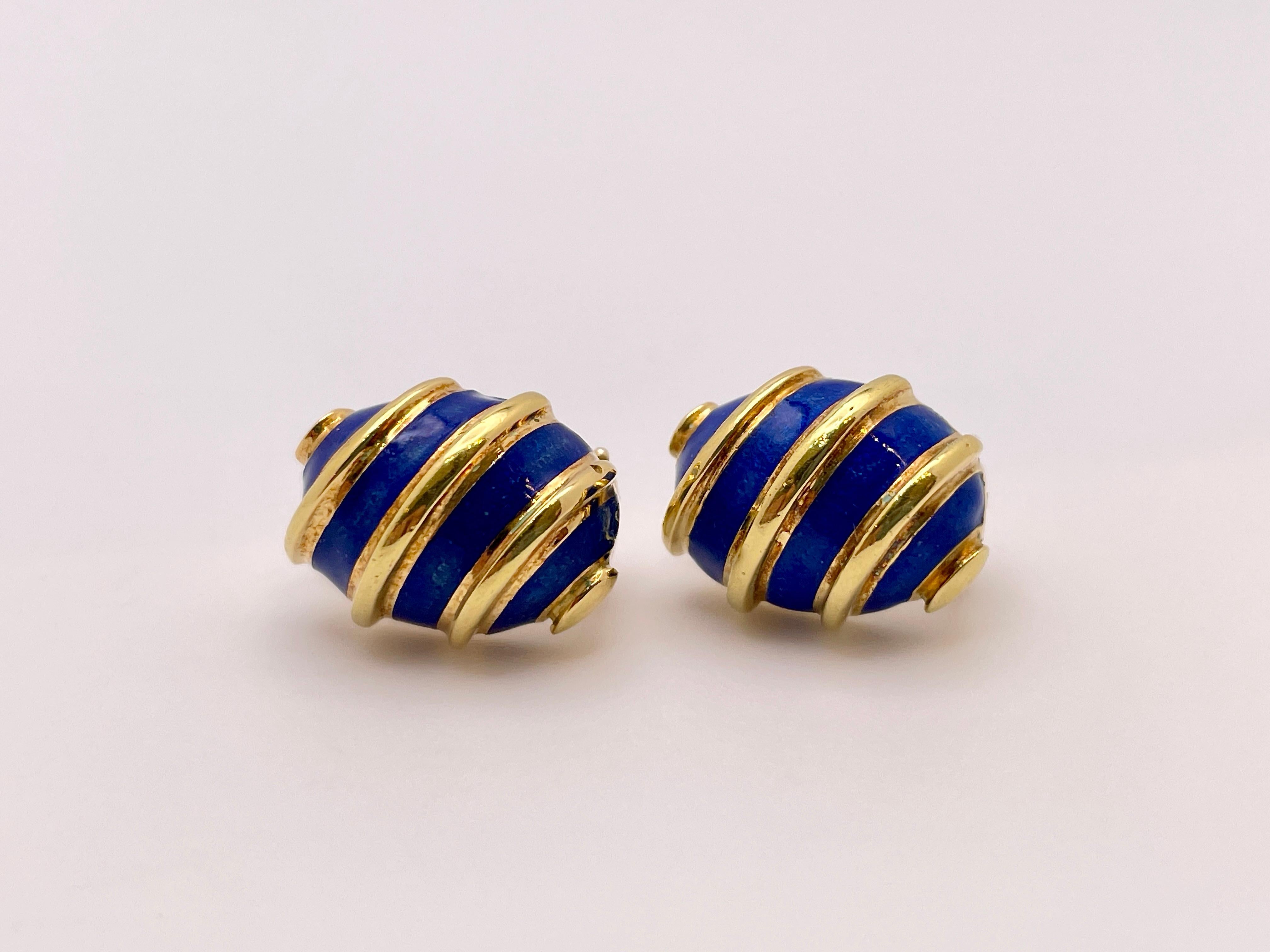 An 18K yellow gold Tiffany & Co. Schlumberger blue enamel earrings. These earrings feature a gorgeous ocean-blue enamel between the raised golden bars. Both are signed Tiffany 18K Schlumberger. These earrings are vintage, Circa 1980's, and have a