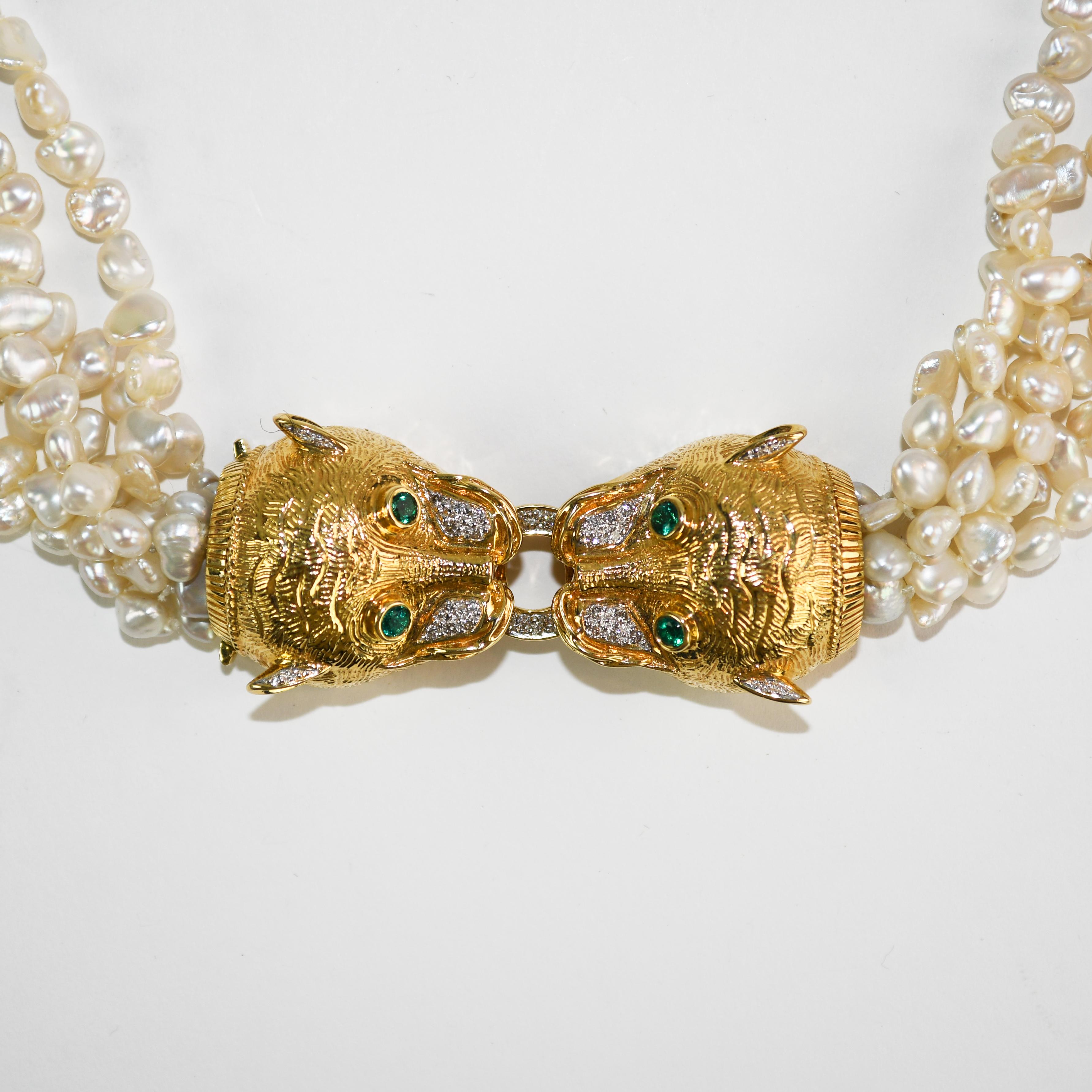 Custom made 18k yellow gold tiger & pearl necklace.
The tiger head clasps are stamped 18k 750 and weigh 48 grams of 18k gold.
There are small round brilliant cut diamonds, .15 total carats, very good quality.
The green stone tiger eyes are too small