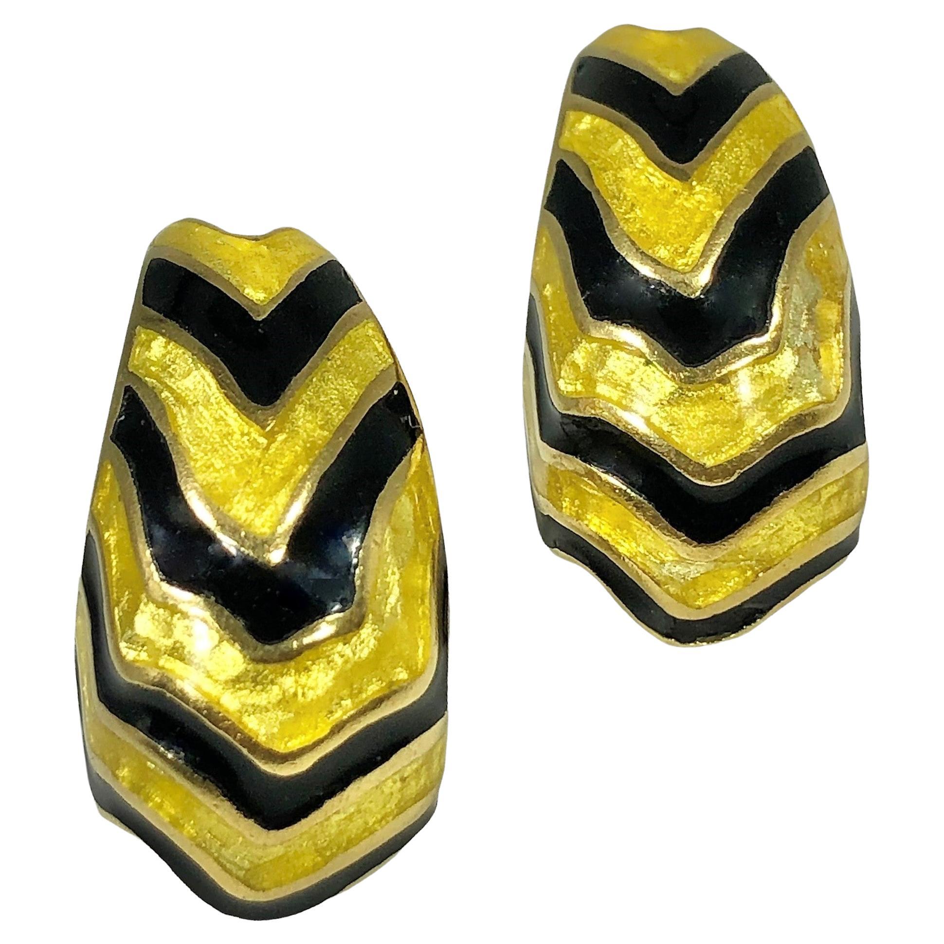 This 18K yellow gold pair of  Mid-20th Century clip on earrings with posts are simple yet visceral. Shimmering transparent gold enamel and jet black opaque enamel stripes in visually exciting patterns are a true delight to behold.  Measures 1 1/8