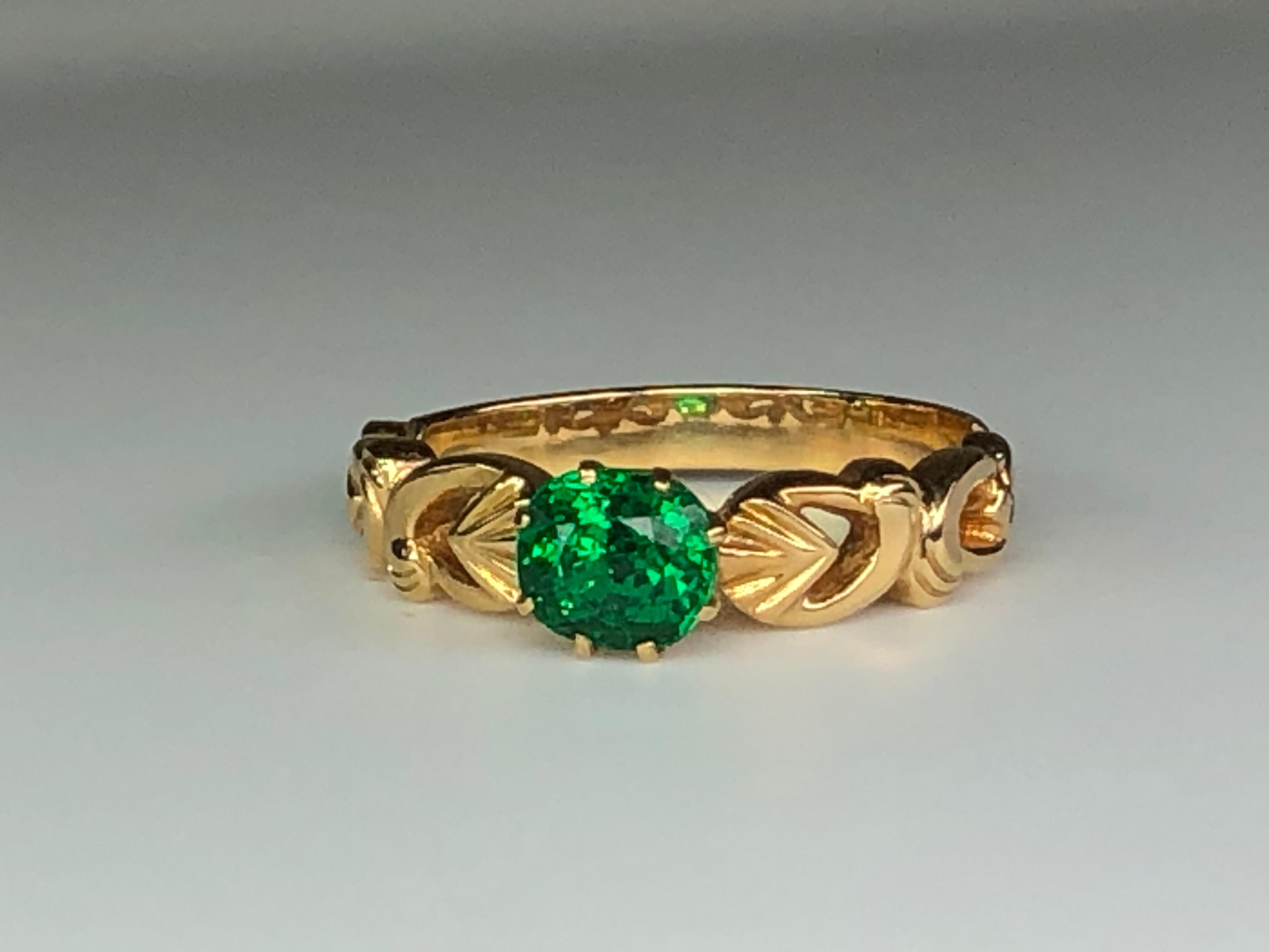 Absolutely stunning piece of the handcrafted ring! The stone layout is unique, colorful, and beautiful. The setting is accented nicely by hand engraved details on both shoulders. Really beautiful ring with a clean and strong fire Tsavorite. Would