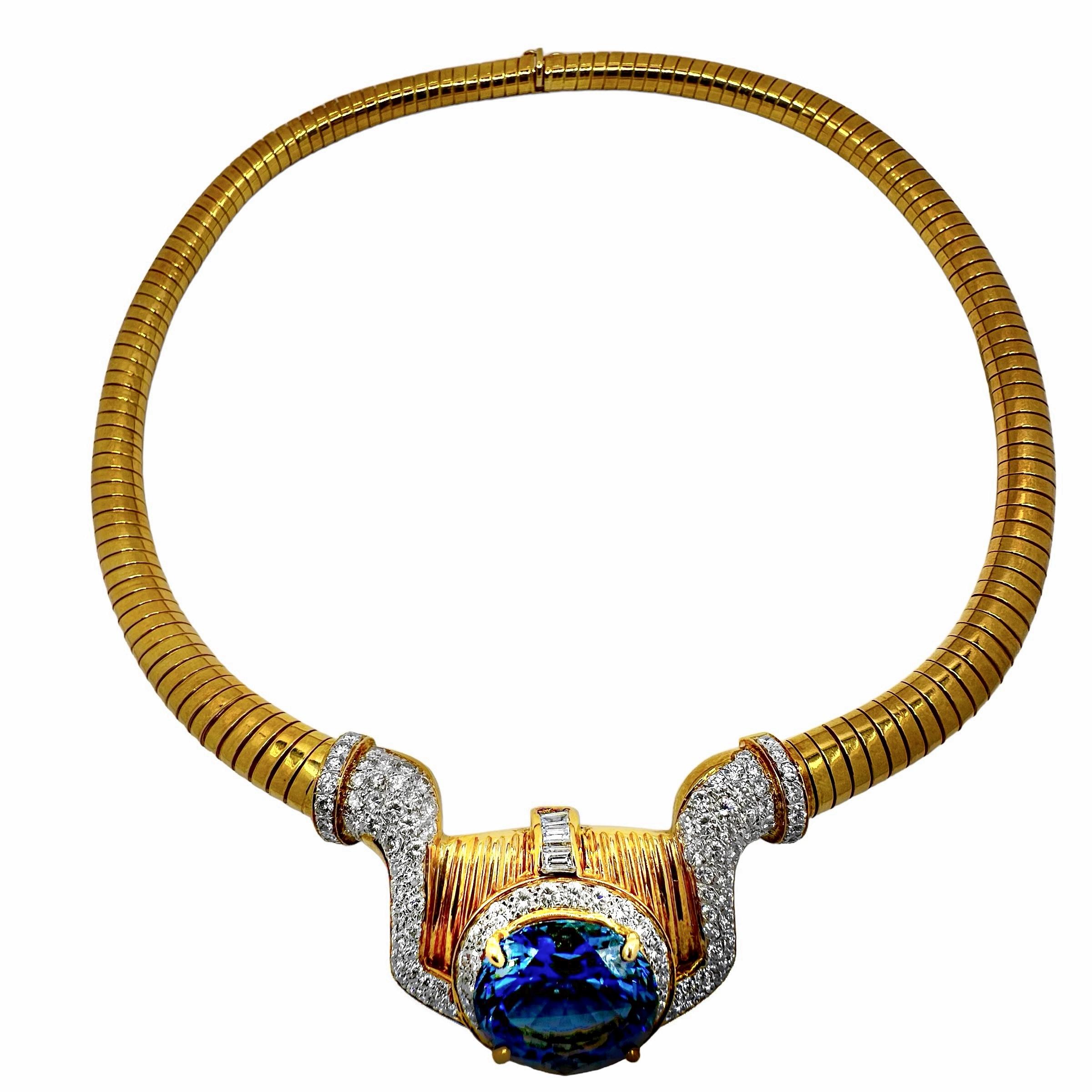 Centered around a vibrant blue/violet Tanzanite, this sleek necklace is an eye catcher. The stunning oval shaped Tanzanite weighs almost 13ct (approximately 12.85ct) and is surrounded by round brilliant cut diamonds. The diamonds then extend to the