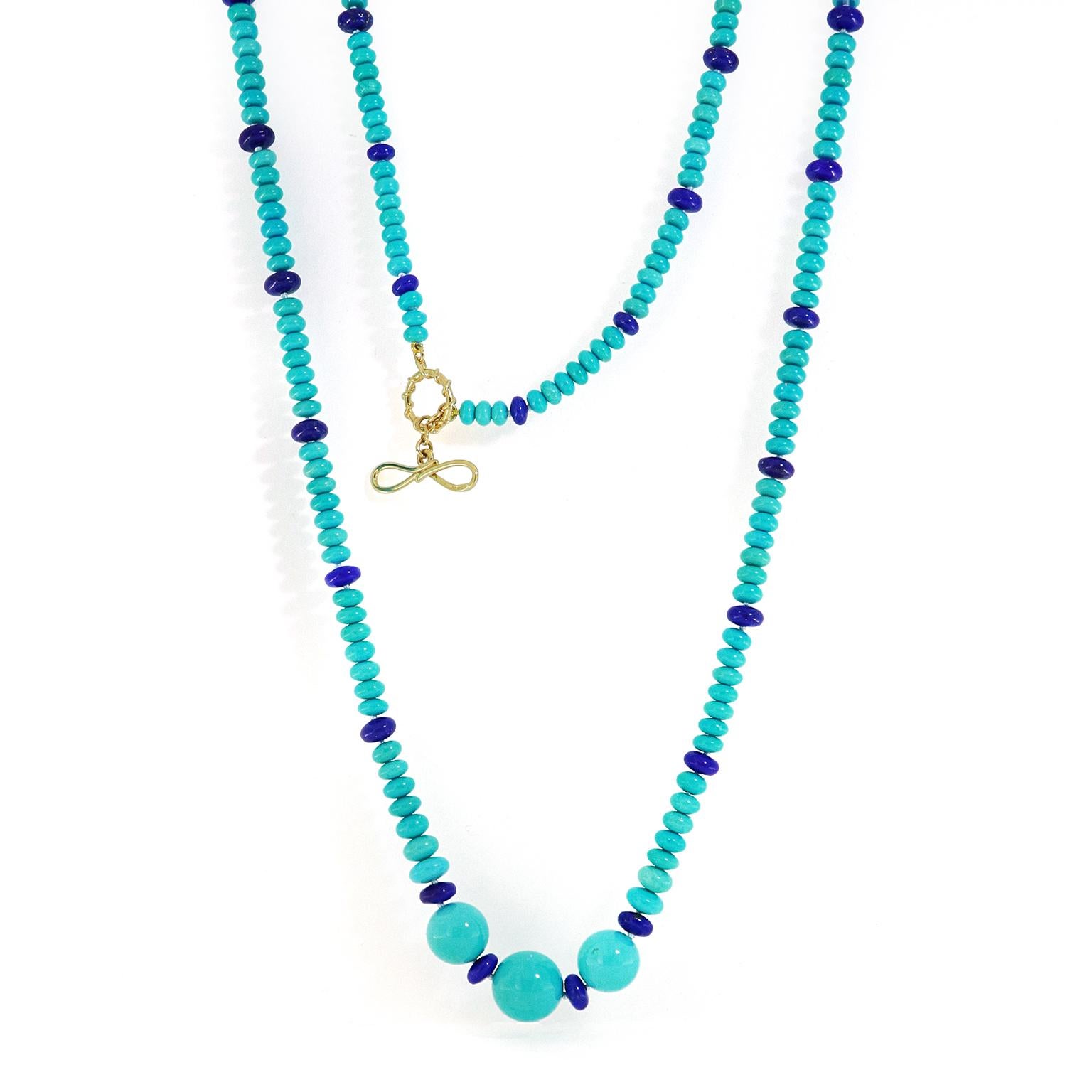 The enchantment of turquoise amplifies against lapis lazuli in this necklace. Turquoise rondelles, strung on dark knotted thread, showcase the soft hues of the blue-green gem. In between every seven is a single lapis rondelle. Toward the center, the