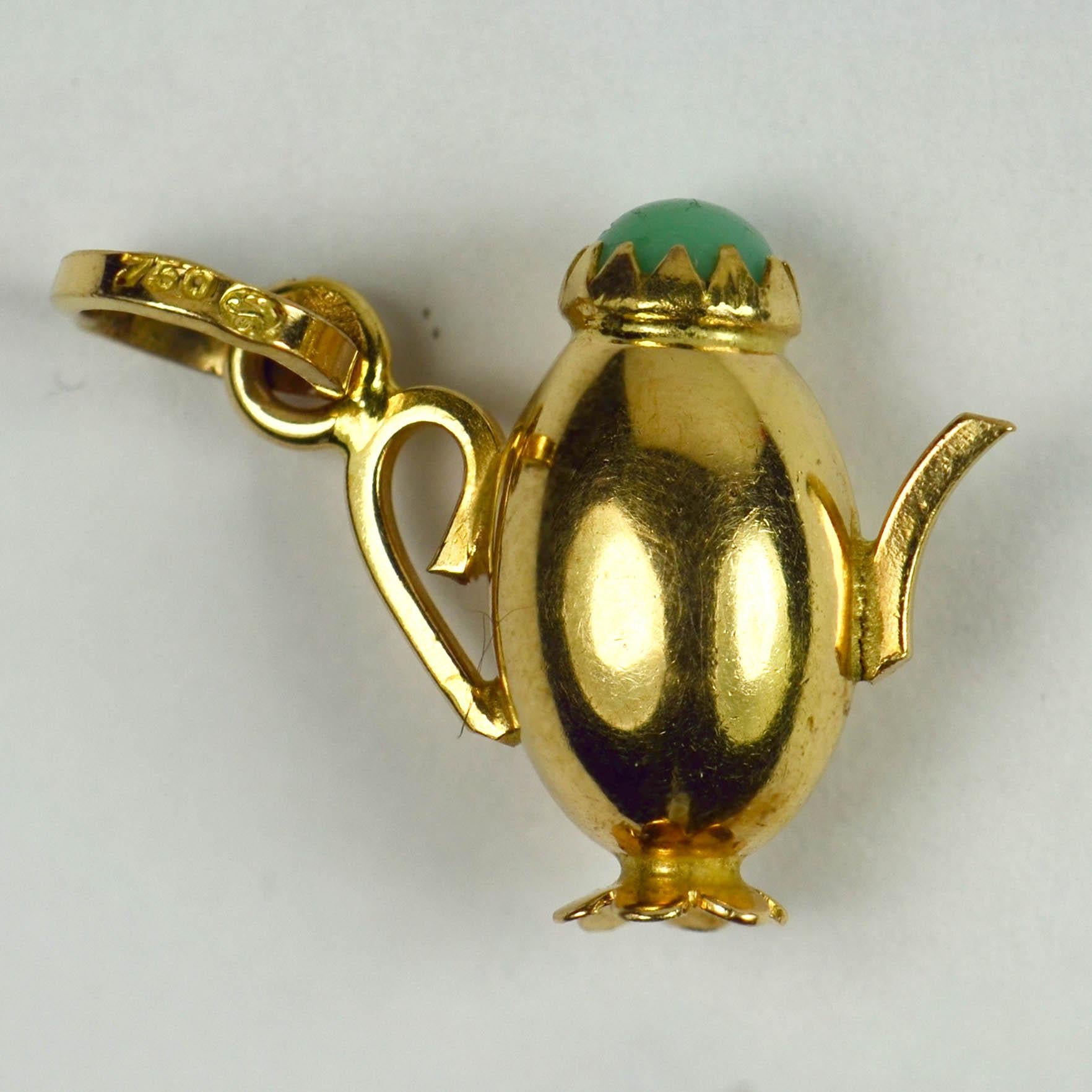 An 18 karat (18K) yellow gold charm pendant designed as a coffee pot with turquoise paste cap. Stamped with 750 and the French import mark for 18 karat gold between 1984-1994 along with an unknown maker's mark.

Dimensions: 1.7 x 2 x 0.9 cm
Weight:
