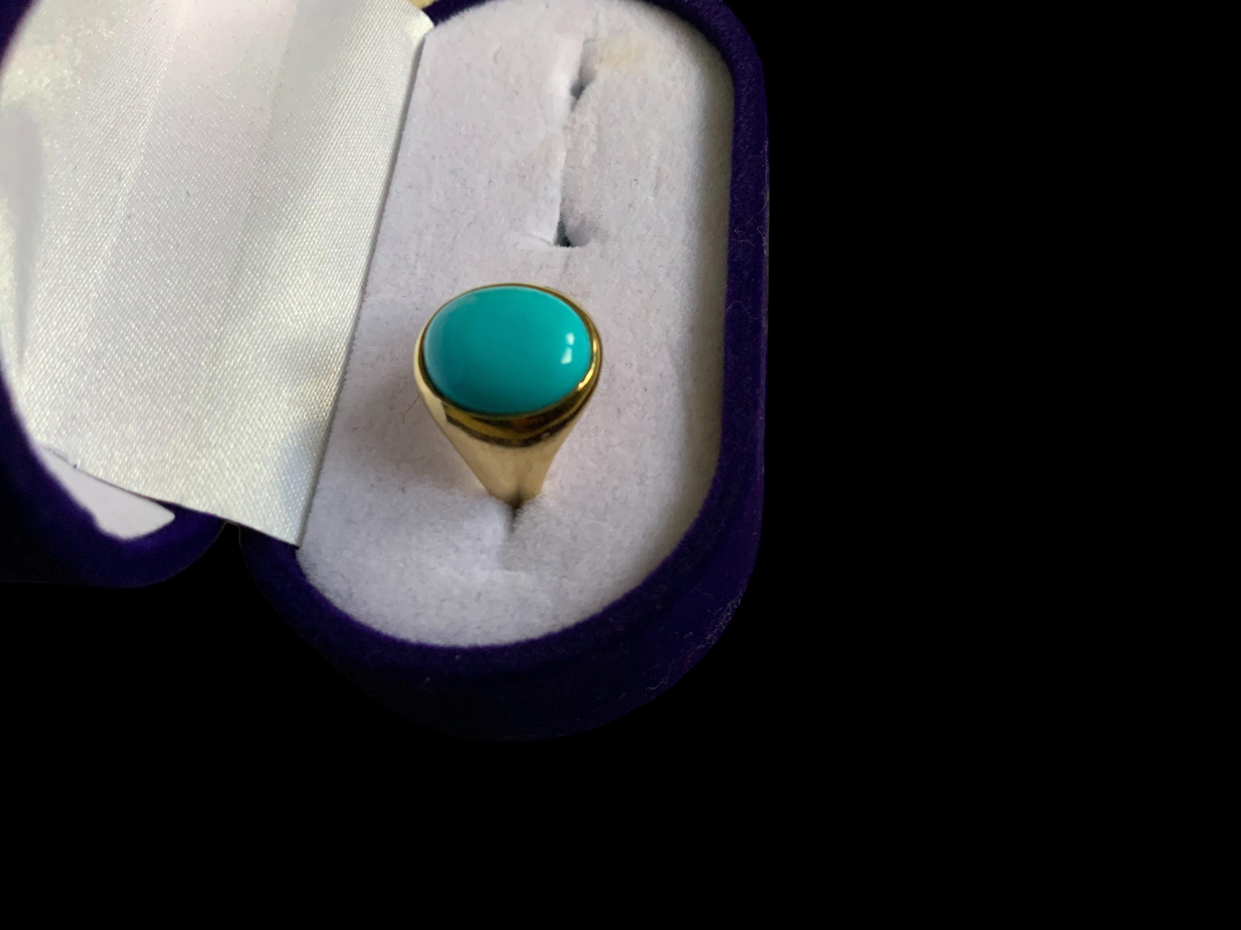 This is an 18K yellow gold and Turquoise ring. It depicts an oval shaped cabochon Turquoise stone mounted in gold bezel setting. The Turquoise’s width and length is 0.4 and 0.5 inches, respectively. The ring is signed 18K behind one of the shank.
