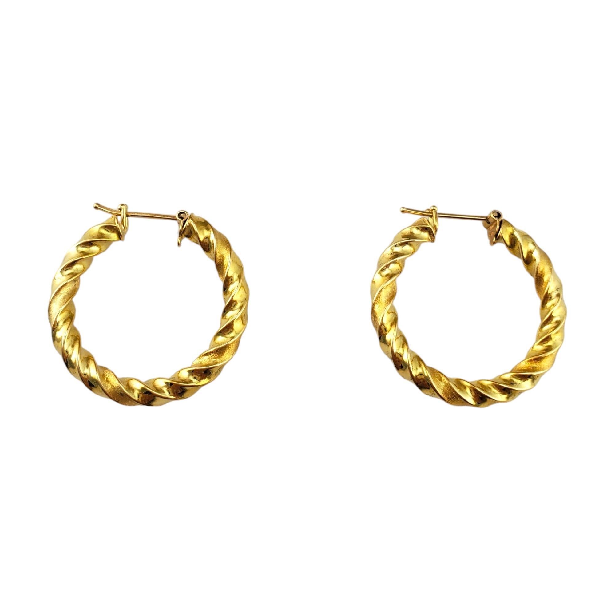 18K Yellow Gold Twist Hoops 

Add a touch of contemporary elegance to your jewelry collection with our 18K Yellow Gold Twist Hoops. Crafted from genuine 18K yellow gold, these hoops feature a modern twist design that sets them apart from traditional