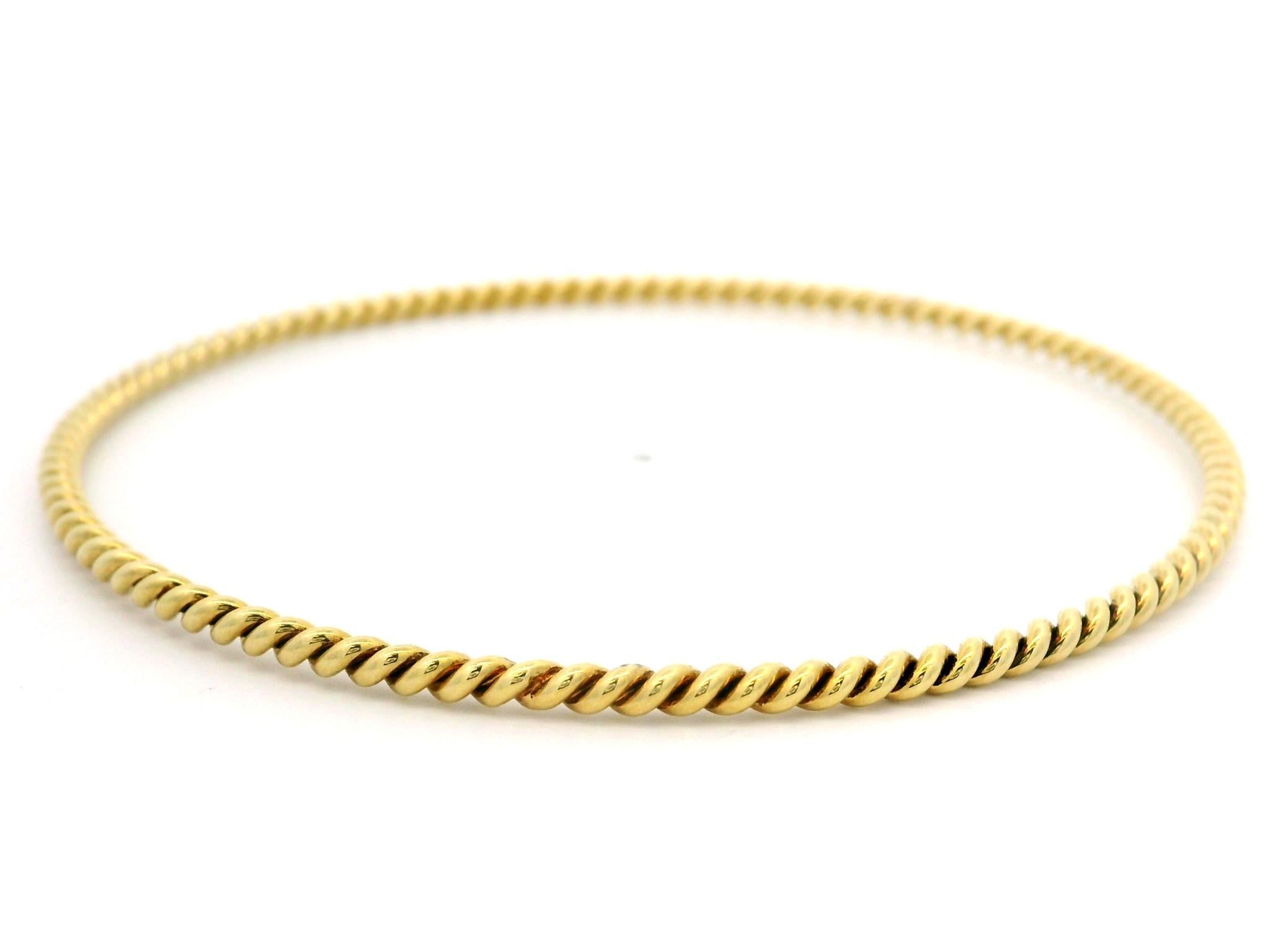 Material: Solid 18k Yellow Gold
Weight: 9.58 Grams
Type: Slip On bangle 
Overall Length: Will comfortably fit up to 8.0” (measured on wrist)
Overall Width: 65.72mm (2.58
