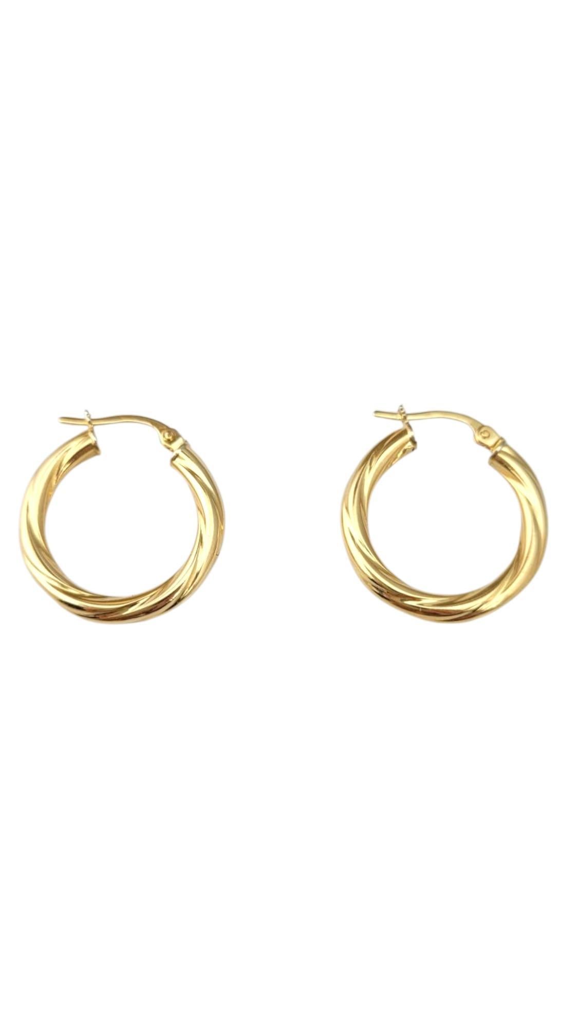 18K Yellow Gold Twisted Hoop Earrings -

These 18K yellow gold twisted hoop earrings feature a stunning, intricately twisted design that adds depth and movement to a classic shape. The rich, warm tone of the gold enhances their elegance, making them
