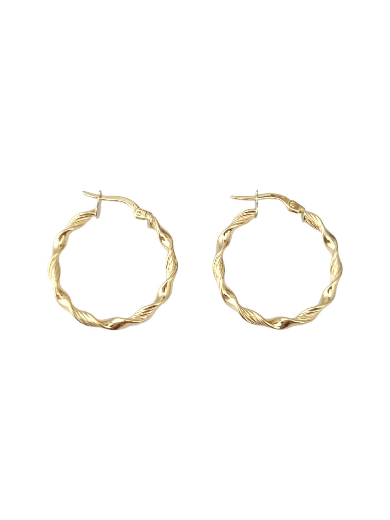 18K Yellow Gold Twisted Hoop Earrings -

These yellow gold twisted hoop earrings showcase a beautifully textured spiral design that adds depth and dimension to a classic silhouette. Crafted in radiant gold, they offer a perfect blend of elegance and