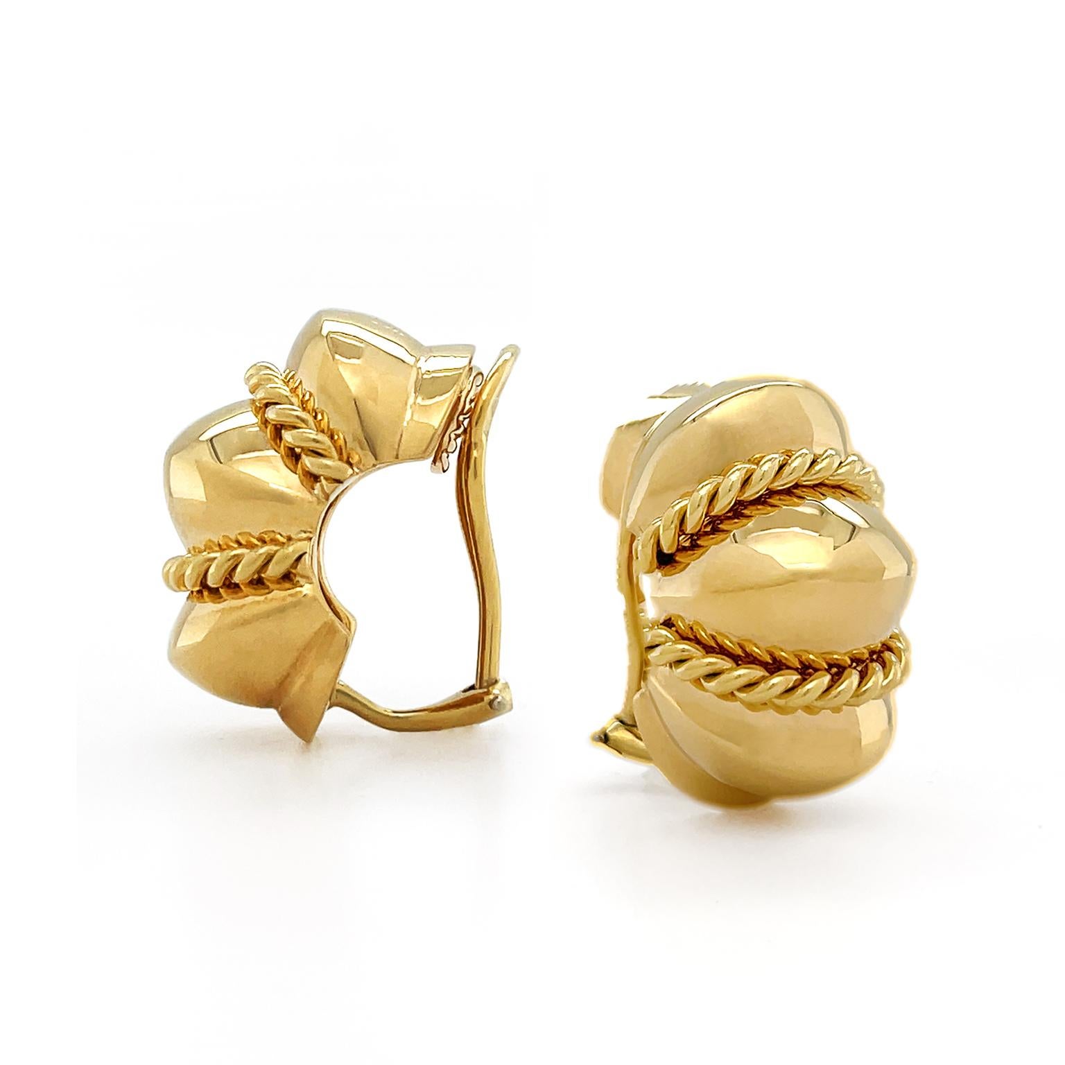 The warmth of vivid gold combines with the elegant shrimp design. 18k yellow gold is molded into the base with three raised structures and smaller indentations. A gold braid wraps around two indentations for a textured highlight, while a high polish