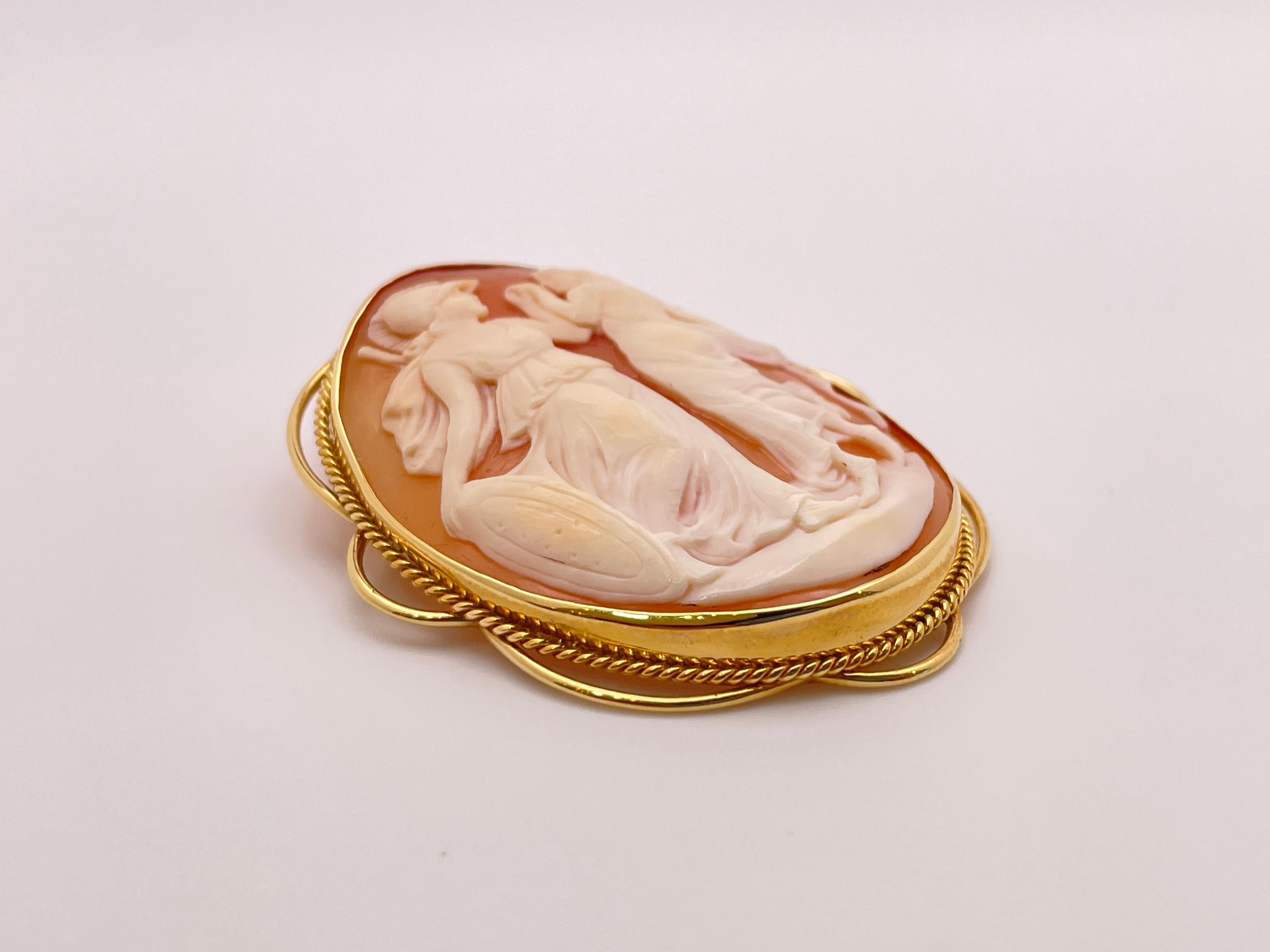 An elegant vintage hand carved Two Roman Graces shell cameo set in an 18K yellow gold setting, with pin and bail.

This cameo depicts Two Roman Graces carved in fine detail, capturing their harmony and charm. They are carved in white color