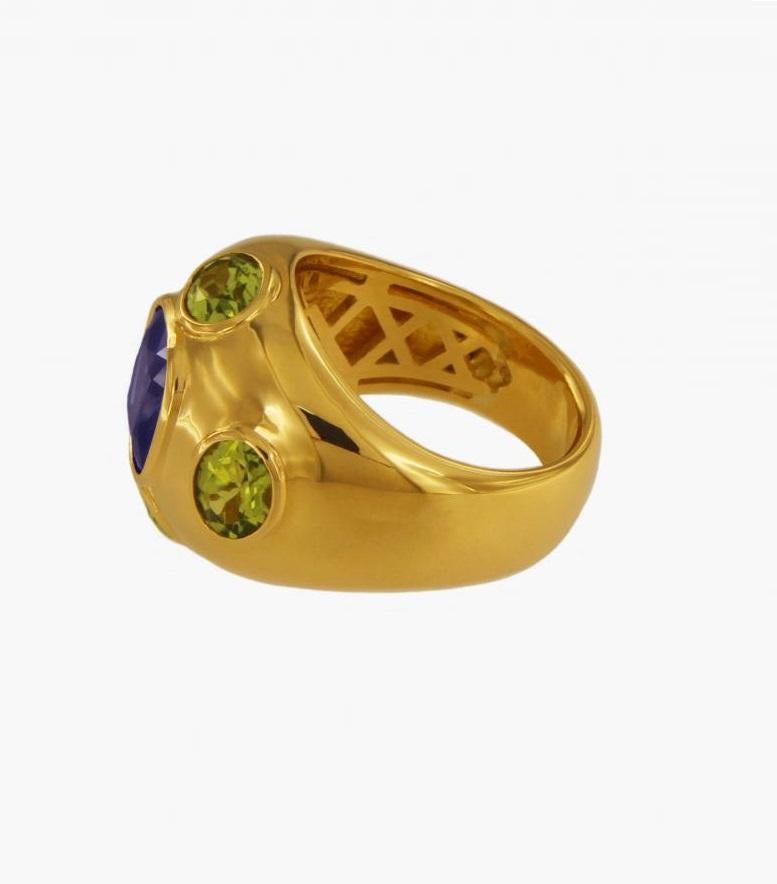Magnificent unisex ring with centered blue sapphire and peridots.

-Custom made
-Ring size: 9.75
-18K yellow gold
-Weight: 21.6gr

SAPPHIRE
-Natural creation
-3.80ct
-9.5 mm

PERIDOTS
-3.50ct

*New without tags
 RETAIL:  $7,500