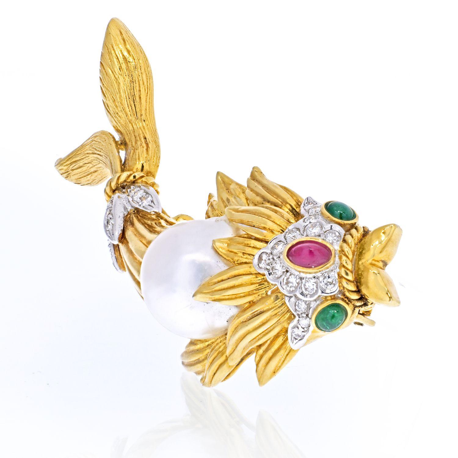 An embellished koi fish pin brooch features a cultured pearl, accented with round diamonds, a ruby and two cabochon green emeralds as 