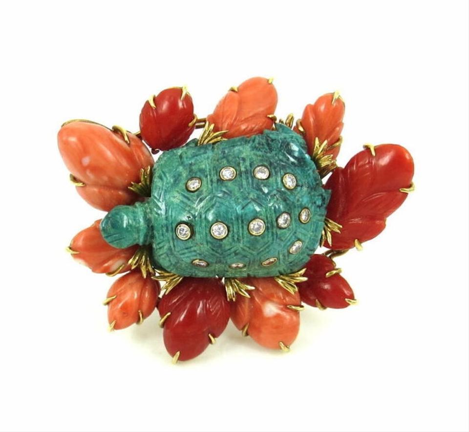 A unique Vintage Turquoise, Coral and Diamond turtle brooch by David Webb. The carved malachite animal inset with collet-set diamonds, surrounded by carved coral leaves, mounted in 18ki yellow gold. Size: 2.2 inches long. Signed Webb for David Webb.