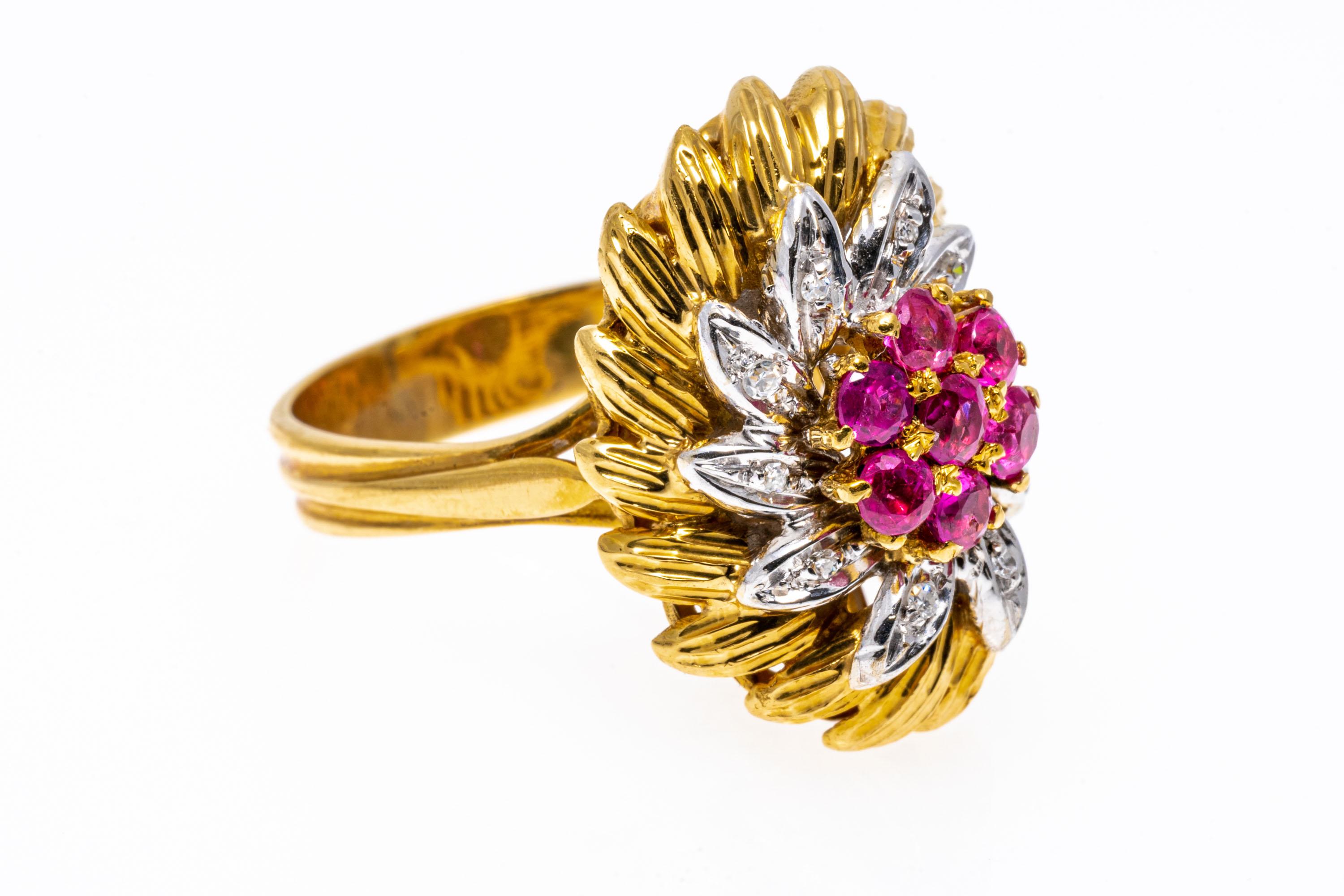 18k yellow gold ring. This fabulous yellow gold vintage ring is an elongated flower cluster style, with a center cluster of round faceted, light reddish pink color rubies, approximately 0.63 TCW, prong set. Surrounding the center is a white gold,