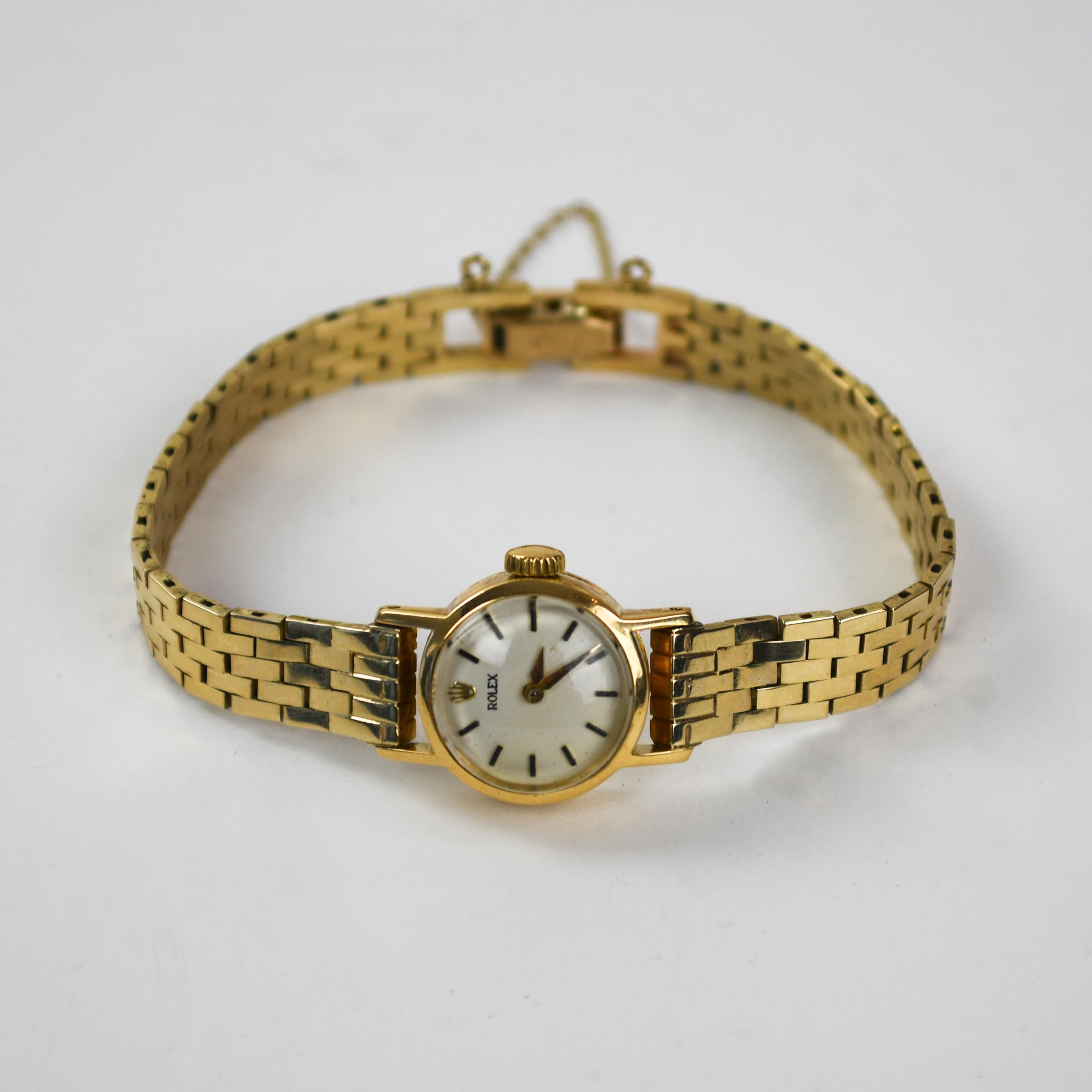 Ladies' vintage 18k yellow Rolex watch case with 13k yellow gold bracelet.
The manual wind 17 jewel movement. The case size is 16mm in diameter.
The back of the case has a faint stamp of a crown and serial number 348396.
The inside of the watch back