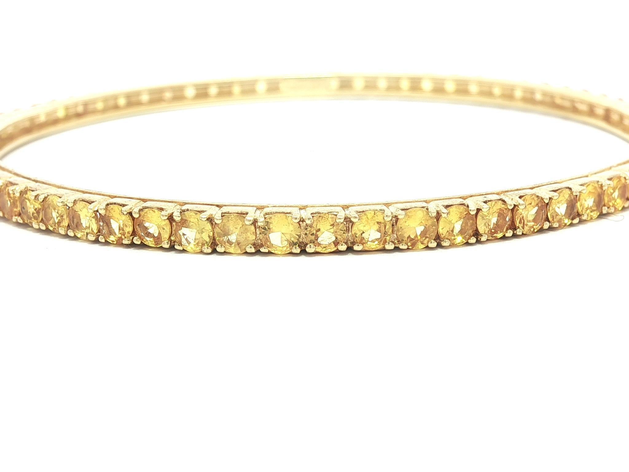 --Pierre(s) :...
Nombreux saphirs naturels authentiques - taille ronde et brillante - sertis - couleur jaune vif - variation naturelle de la couleur - 2,9-3 mm chacun (approx.)

MATERIAL : Or jaune 18K massif 
Poids : 17,41 grammes
Type : Bracelet à