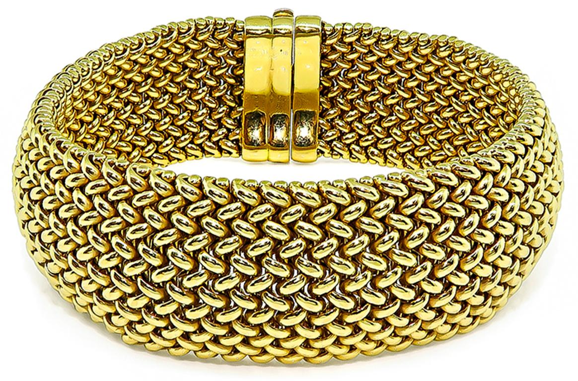Made of 18k yellow gold, this bracelet features a stunning weave motif.
The bracelet measures 21mm in width and 7 1/2 inches in length.
It is stamped 750 and weighs 54.3 grams.



Inventory #54835PEPK