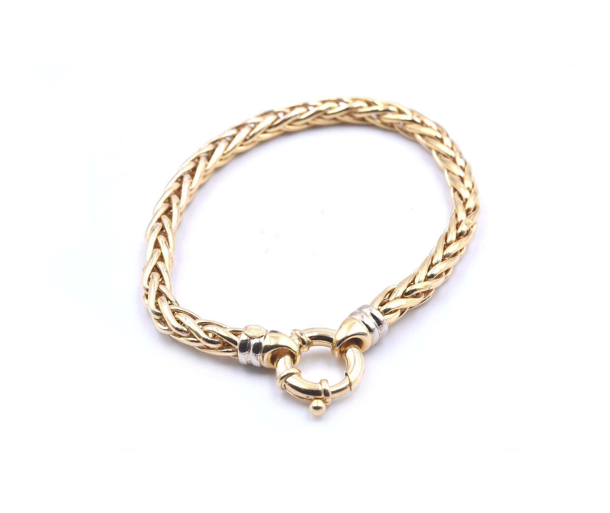 Designer: custom design
Material: 18k yellow gold
Dimensions: bracelet will fit a 7 ½-inch wrist, bracelet is 5.14mm wide
Weight: 12.69 grams
