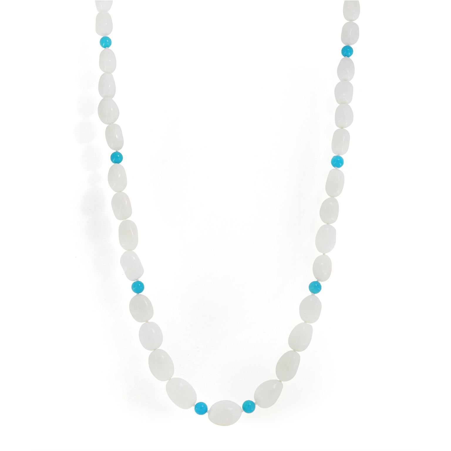 Marine elegance is the heart of this white coral and turquoise necklace. Strand-shaped white corals are strung on a coordinating thread, with a knot between each to ensure protection. Placed throughout the arrangement are individual orbs of