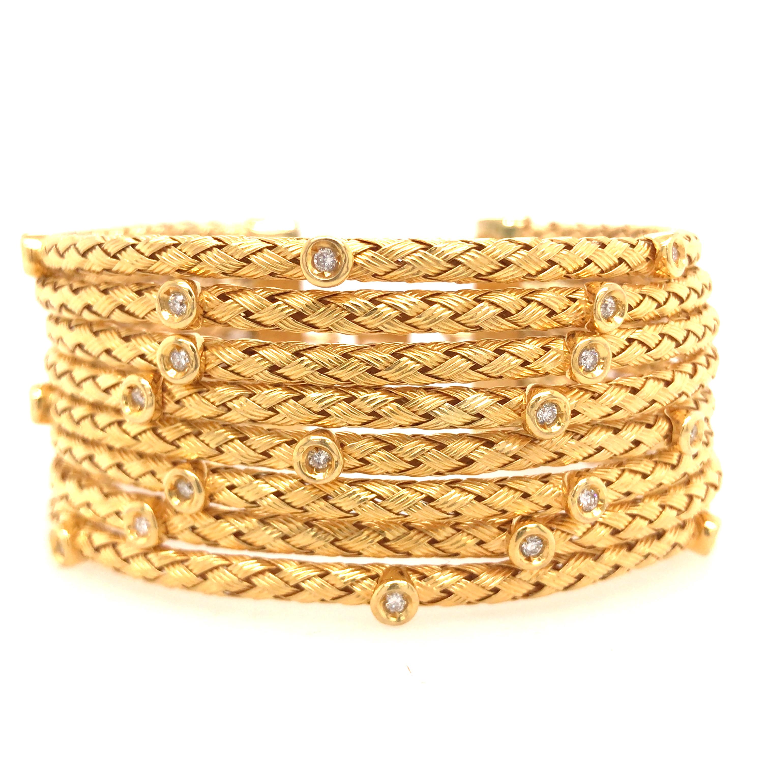 18K Yellow Gold Wide (8) Row Rope Bangle with Diamonds. (20) Round Brilliant Cut Diamonds weighing 0.88 carat total weight, G-H in color and VS-SI in clarity are expertly Bezel set on the Gold Ropes. The Bracelet is flexible and measures 6 1/4 inch