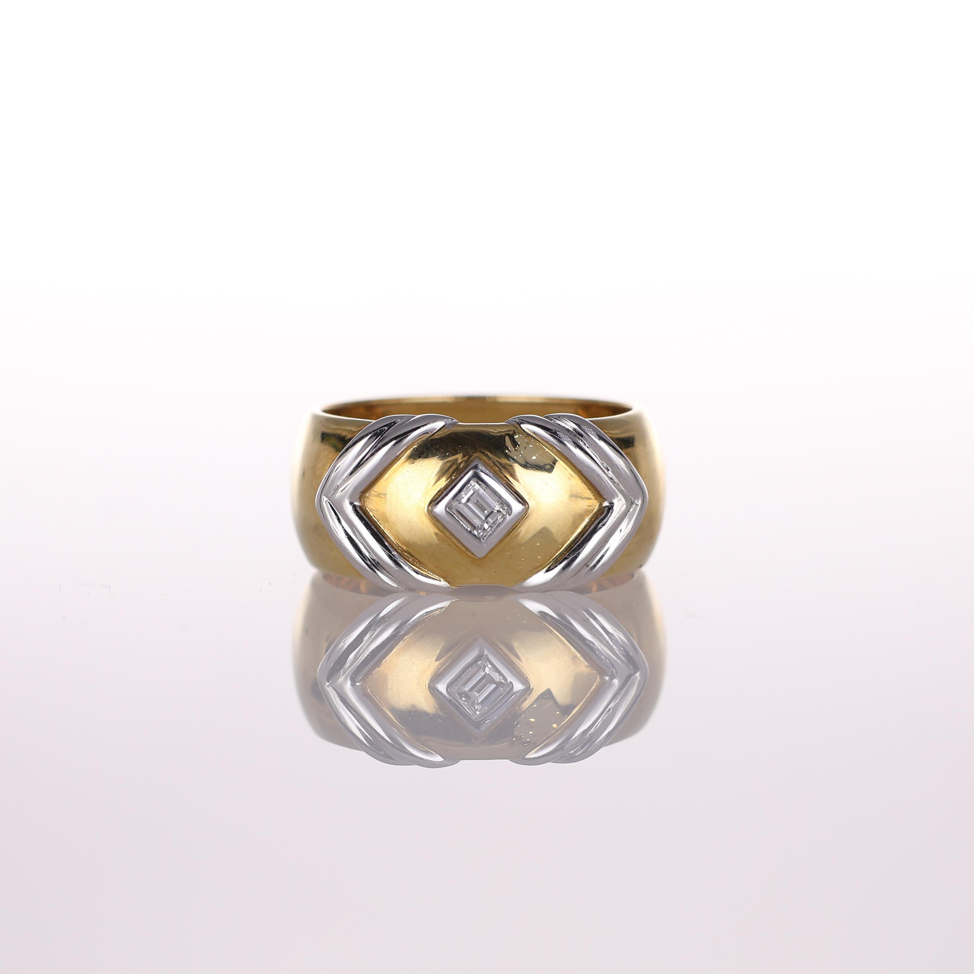 A bold and distinctive wide band ring crafted in 18K yellow gold, featuring sleek white gold arrow accents and set with 0.05 carats of brilliant-cut diamonds. The geometric design adds a modern touch to the classic gold band, making it a striking