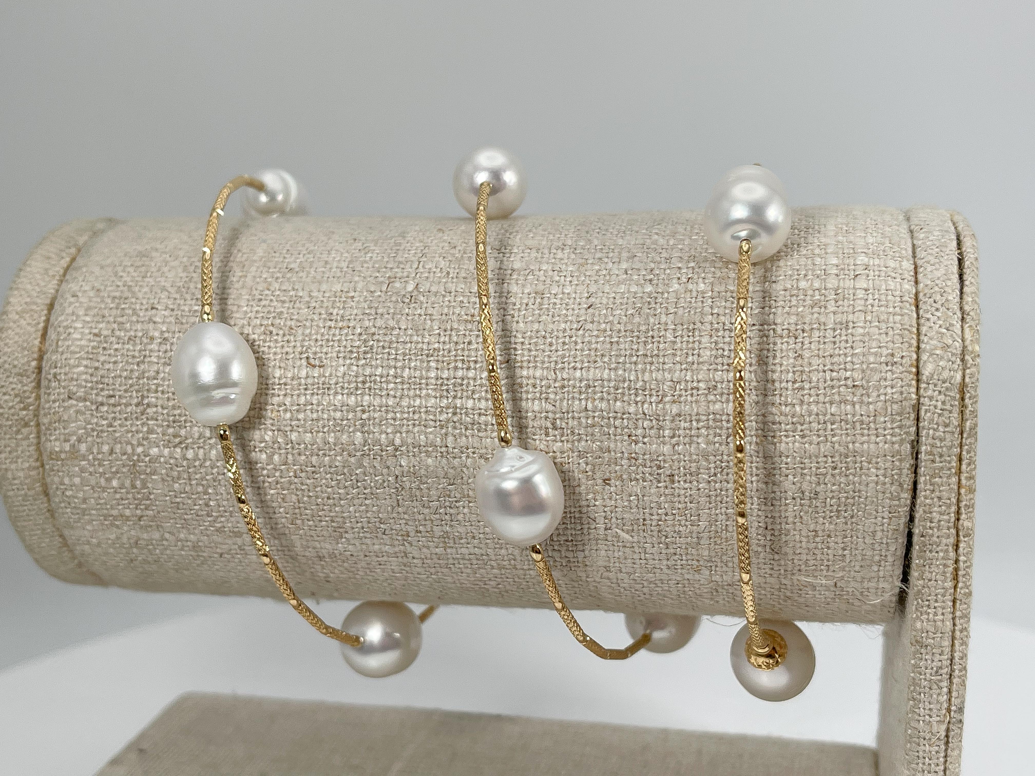18k yellow gold wire cable white pearl bracelet. This bracelet will stretch to fit almost anyone, the width of the pearls is 9 mm, and it has a total weight of 20.86.