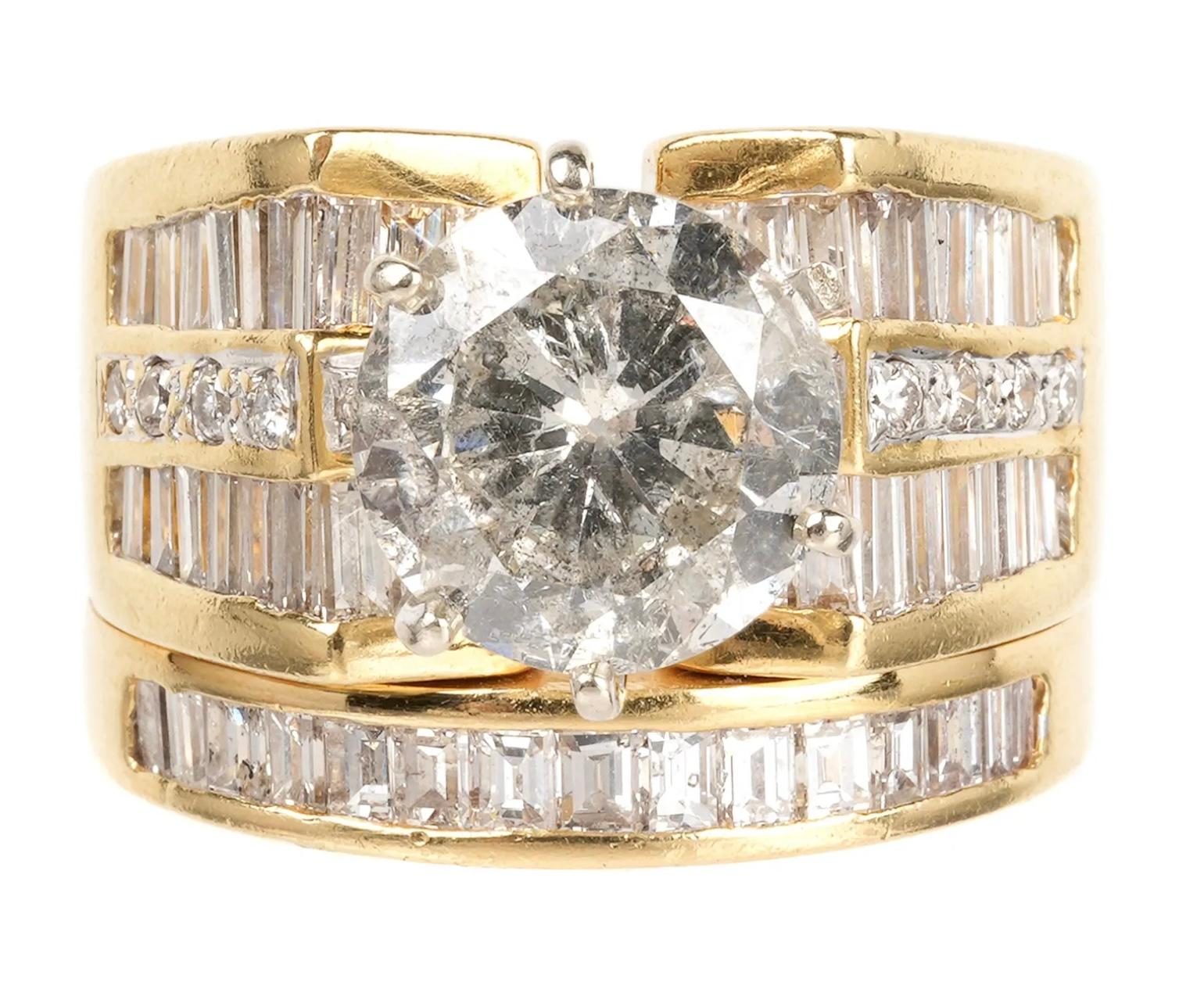 Stunning 18k yellow gold with 5.91 ctw diamond bridal set, size 6.5, that includes:
1) Engagement ring prong set center diamond, approx. 3.15cts, I2 clarity, J in color.  36 channel set baguette diamonds, total approx. 2.16ctw, VS-2 to SI1 in