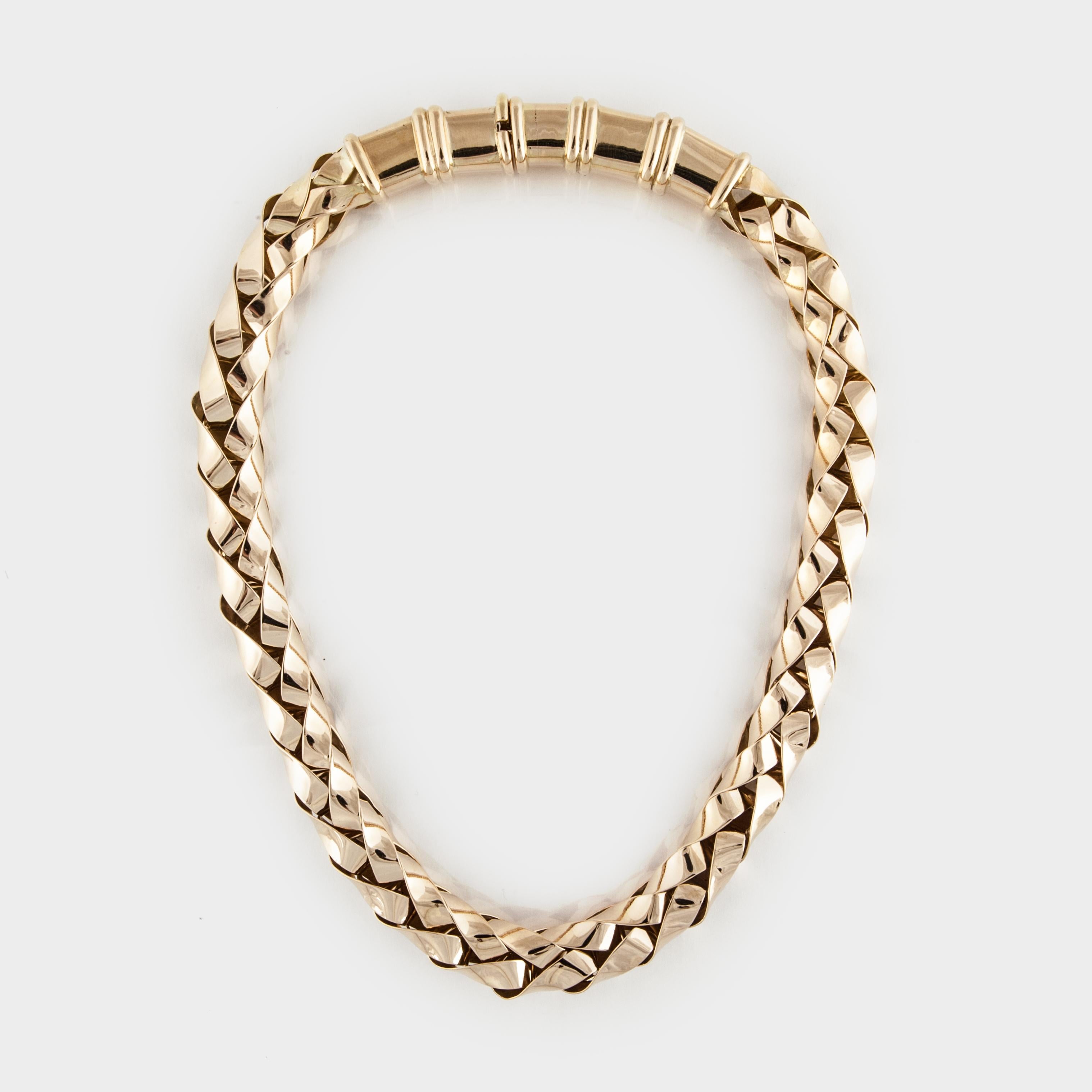 18K yellow gold necklace in a woven style.  It is tubular with a very heavy tongue closure and latch safety.  Measures 18 inches long and 7/16 inches wide.  Bold piece.