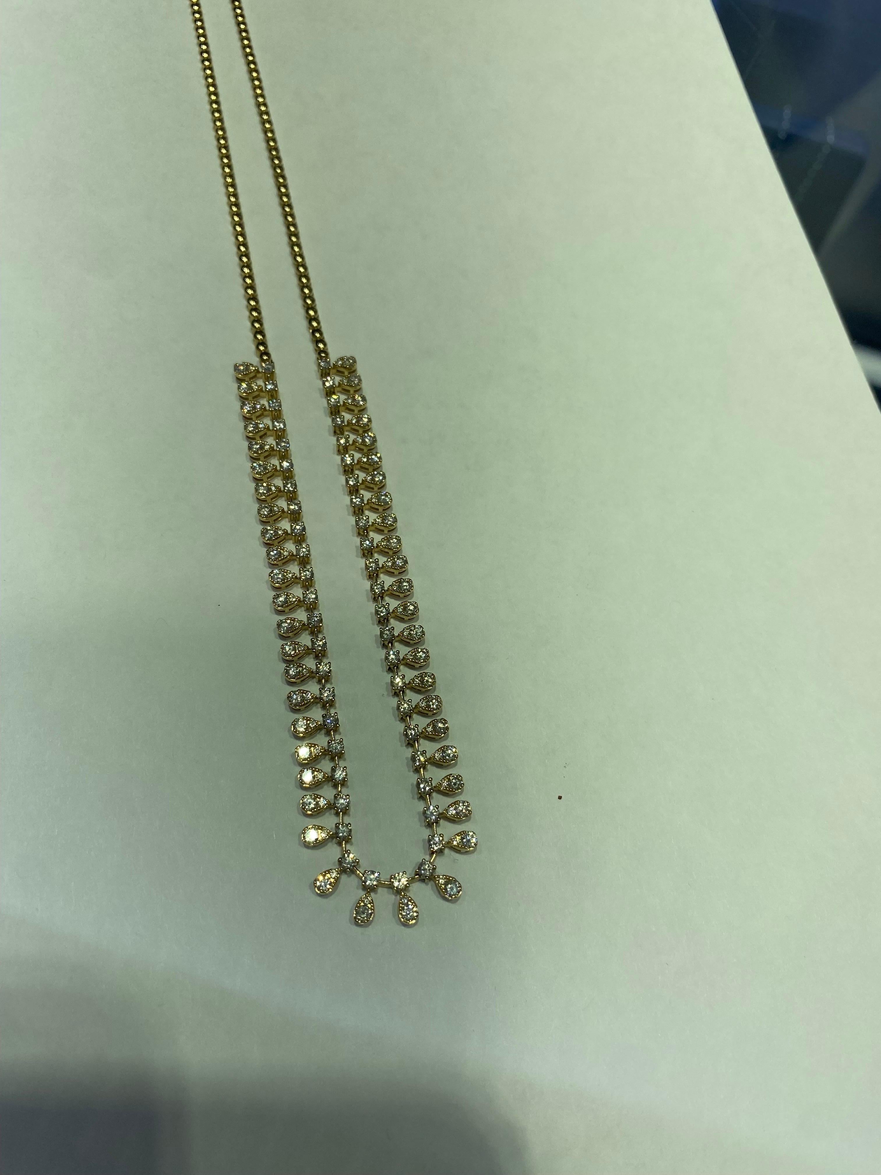 Diamond necklace set halfway in 14K yellow gold. The necklace is set with round diamonds in a pear shaped setting. The total weight is 4.26 carats. The color of the stones are G, the clarity is SI1-SI2. The necklace is 17 inches in length.