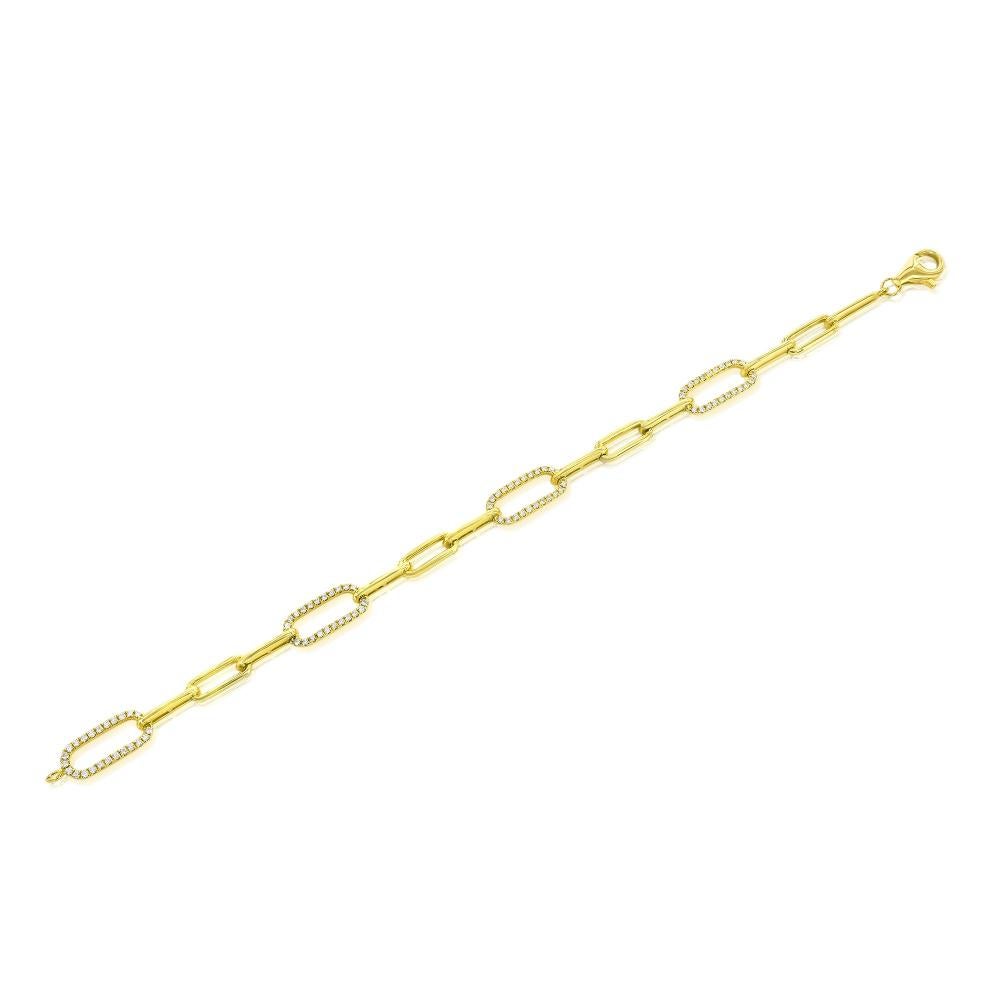 Paperclip bracelet set in 18K yellow gold. The bracelet is set with 4 sections of diamonds. The carat weight is 0.65. The color of the stones are F, the clarity is VS1-VS2. The bracelet is measured at 7 inches.