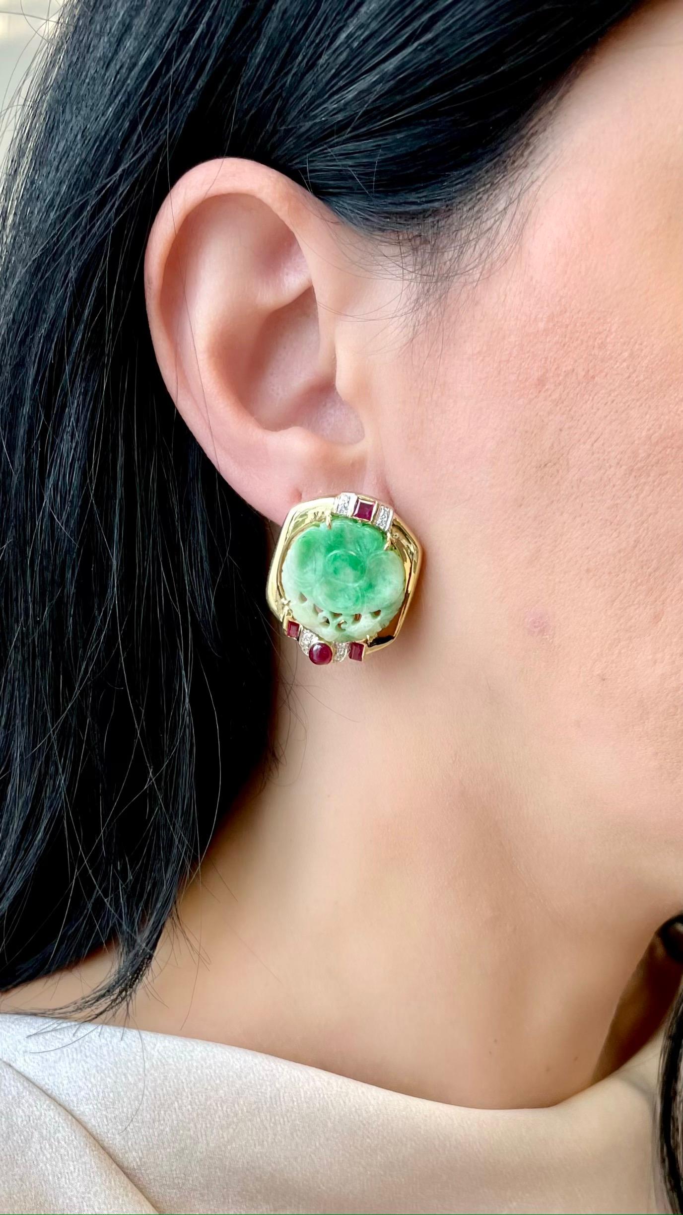 These amazing earrings feature a round-shaped plaque of hand-carved jade with an ornate floral design, rubies & diamond crafted in 18k yellow gold.

The carved jade is prong-set, measuring 21.4 mm x 21.8 mm, and is framed by a high-polish gold