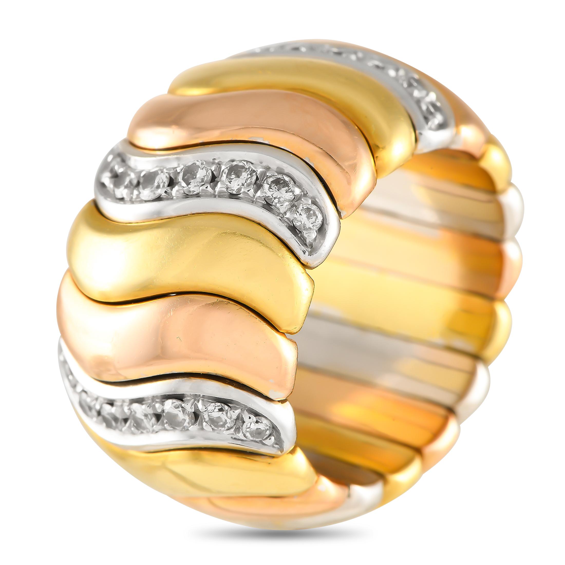 Wavy strips of yellow, white, and rose gold make up the statement-making style of this wide, domed band. The ring also features wavy rows of brilliant diamonds for that unexpected sparkle. The ring's top dimensions measure 17mm x 13mm.This 18K