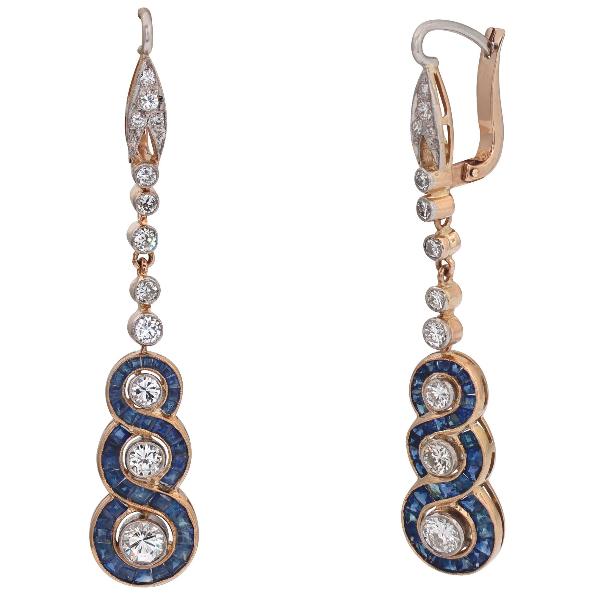 Art Deco sapphire & diamonds drop earrings set in 18 kt yellow & white gold. Round brilliant cut diamonds total approx. weight: 1.50 carat, estimate: G-H color, VS clarity. Step carree cut sapphire total approx. weight 1.00 carat. Post with clip.