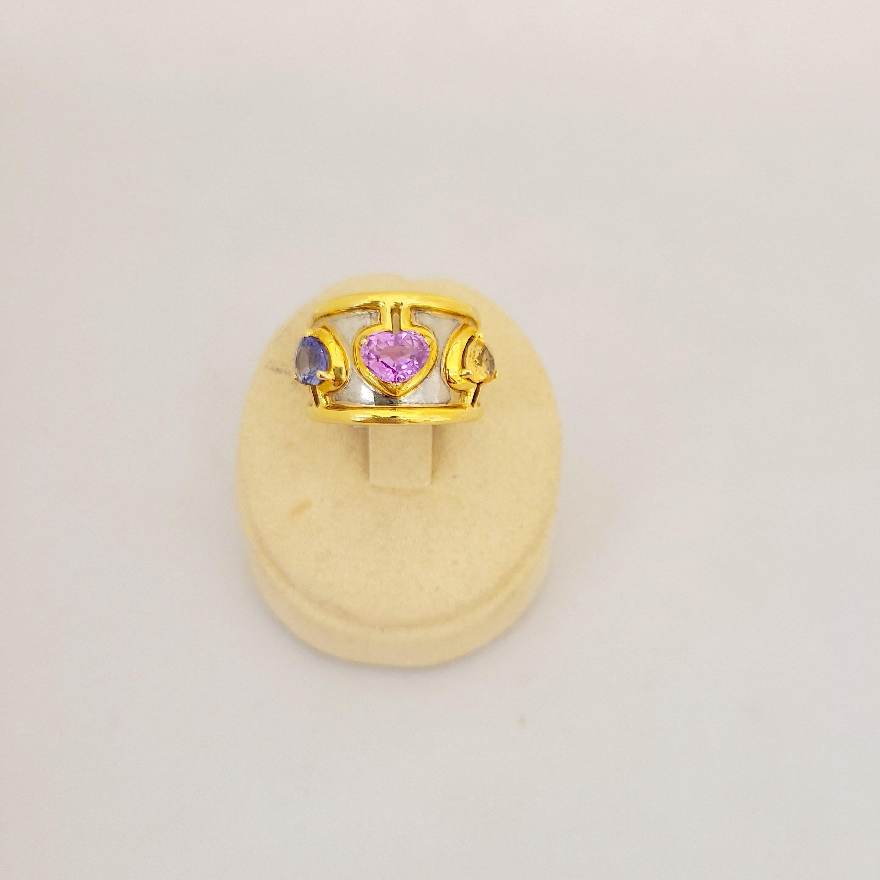 The perfect wedding band, valentine gift, or just happy for everyday, this 18 Karat Yellow and white Gold band features Yellow, Pink & Blue Sapphire hearts totaling 4.32Ct. 
Size 6. 
Cellini Jewelers NYC