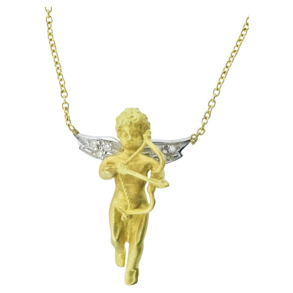 18K Yellow
White Gold Cherub with Diamond Wings holding a Lover
s Bow
Arrow.